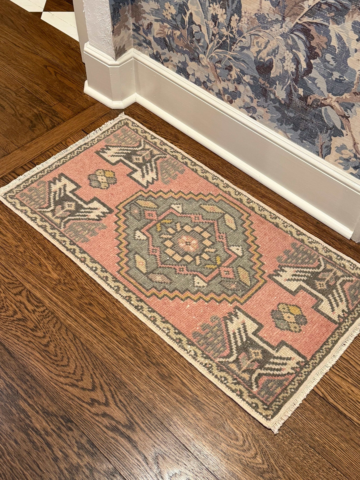 Decorative rug with geometric pattern on a wooden floor