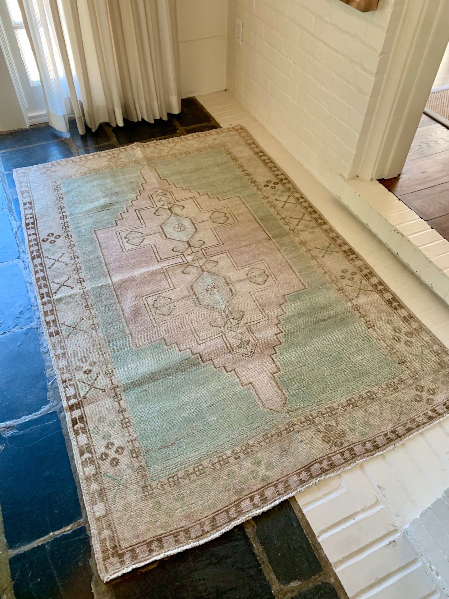 4’2”x6’4” vintage Oushak area rug with aqua, lavender, cream, and brown design.