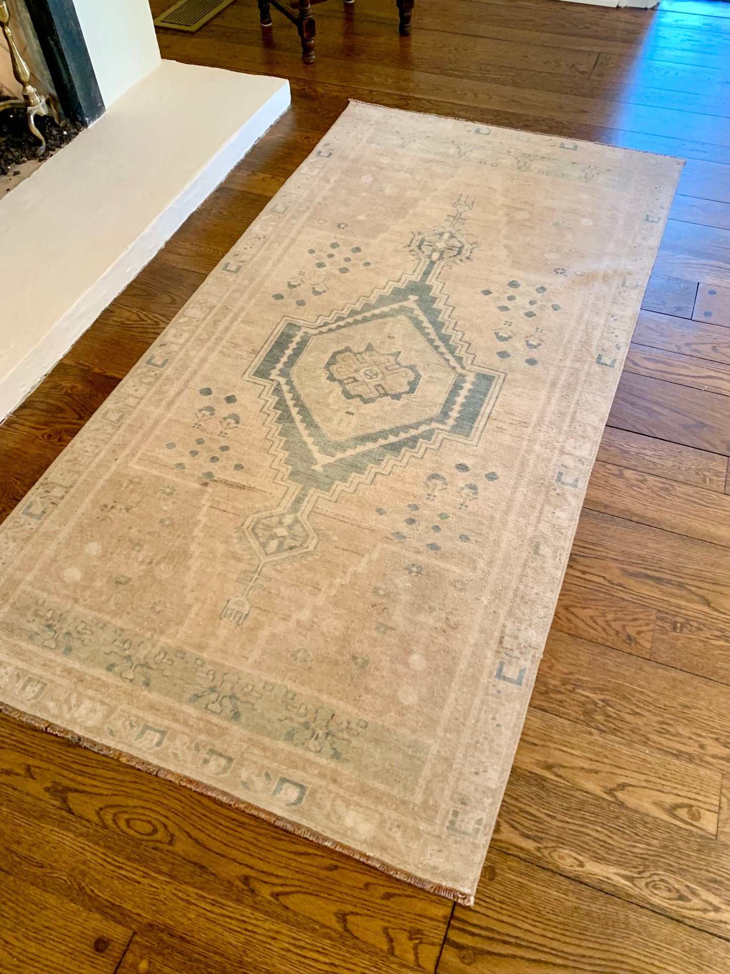 3’5”x7’0” vintage Oushak area rug with light brown and blue detailing.