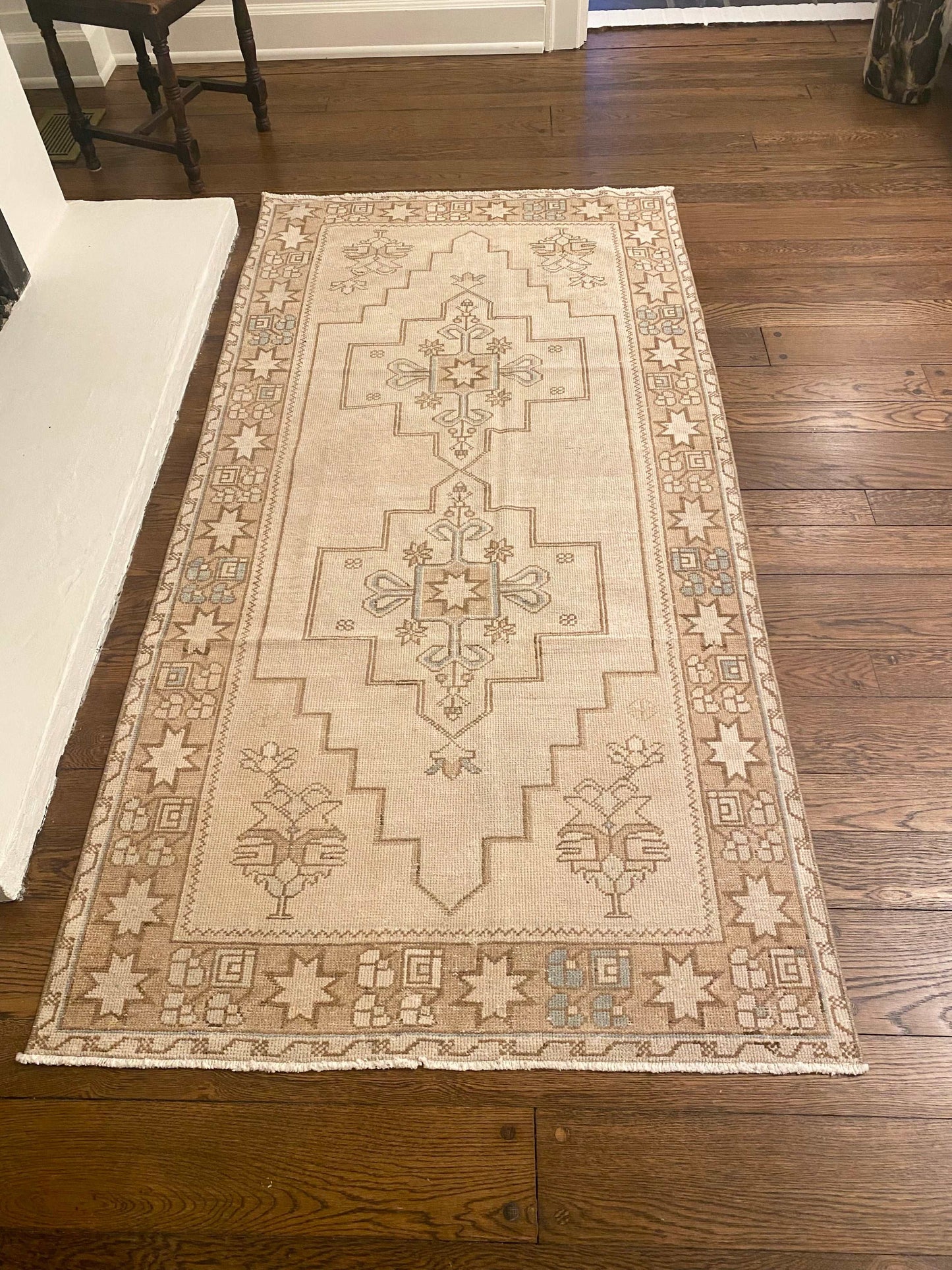 3’9”x7’9” vintage Oushak area rug with light beige, brown, cream, and blue design.