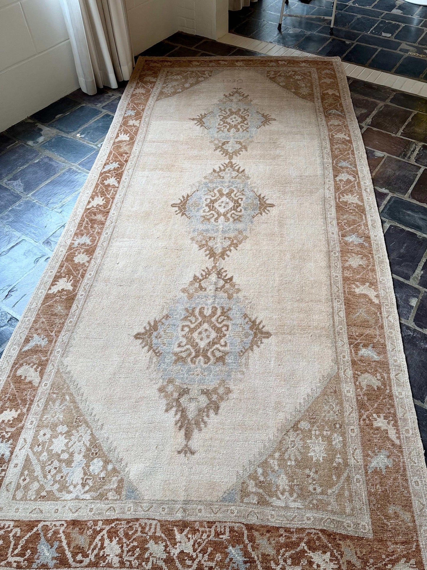 Decorative rug with intricate patterns on a stone floor
