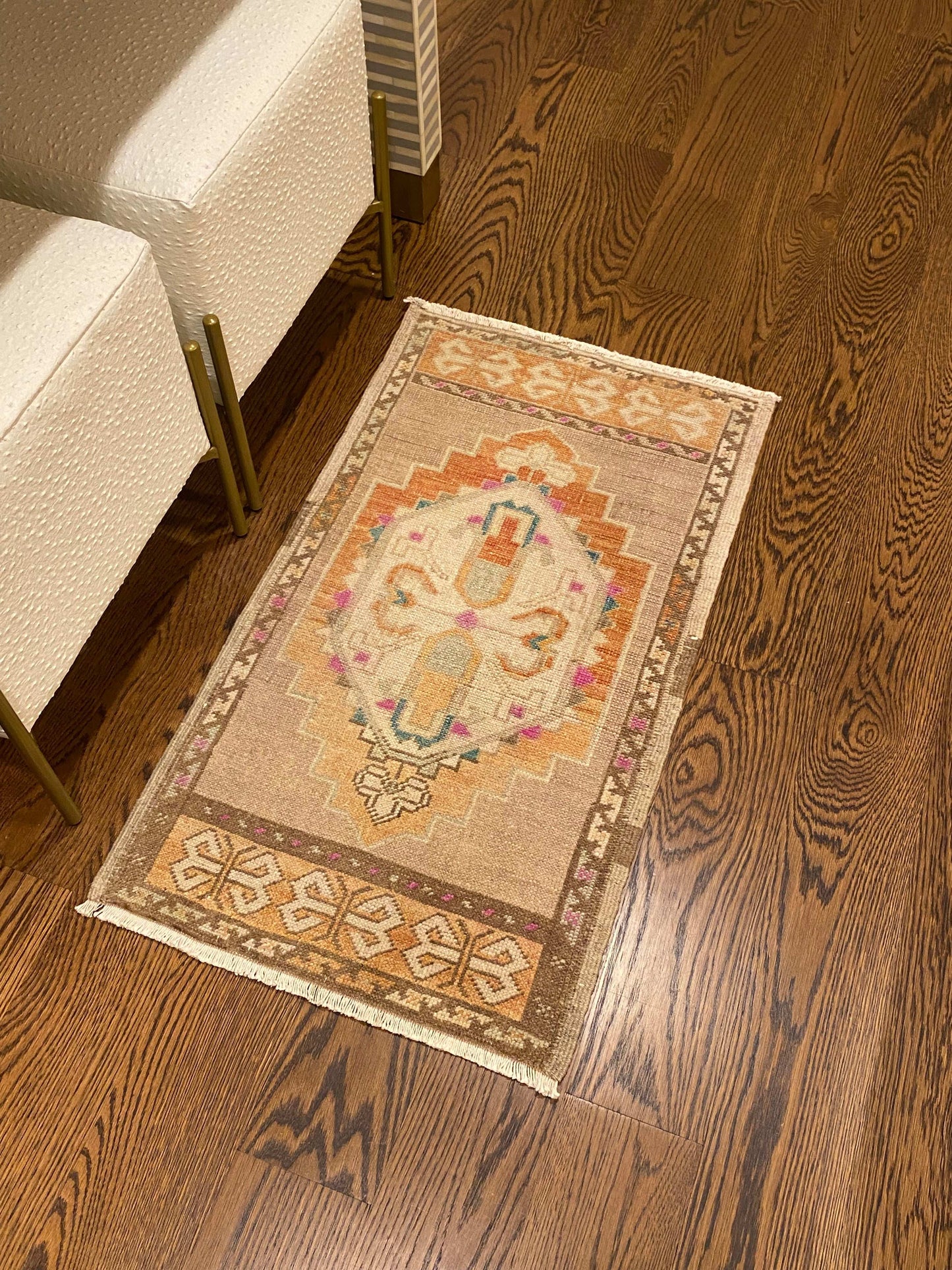 1’8”x2’11” vintage Oushak mat in beige, brown, orange, pink, and blue.