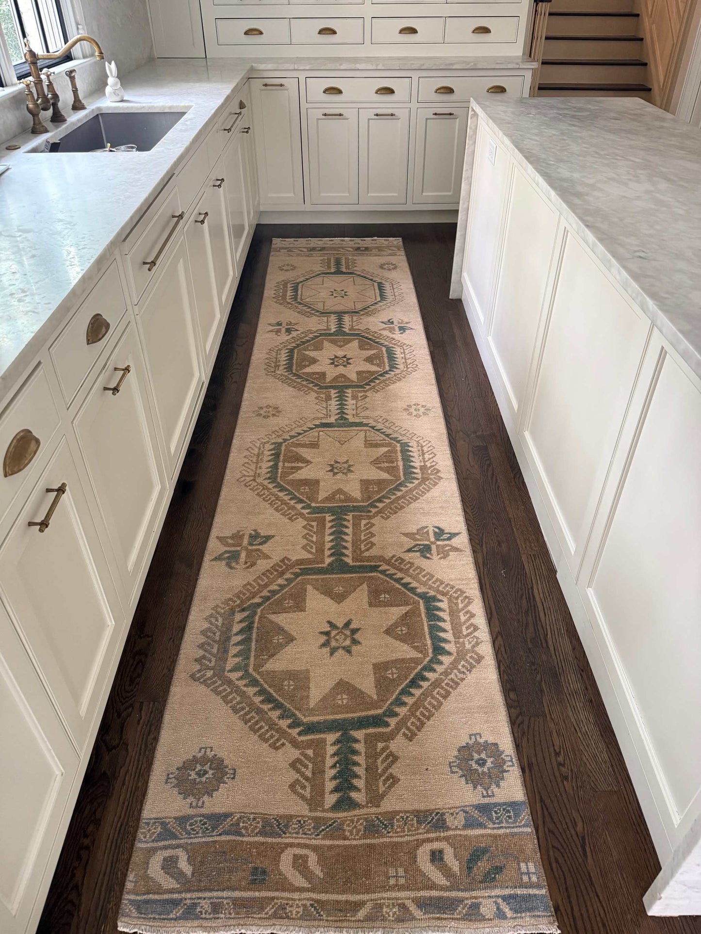 2’8” x 12’3” runner with deep green, blue, brown, and beige accents on a neutral background