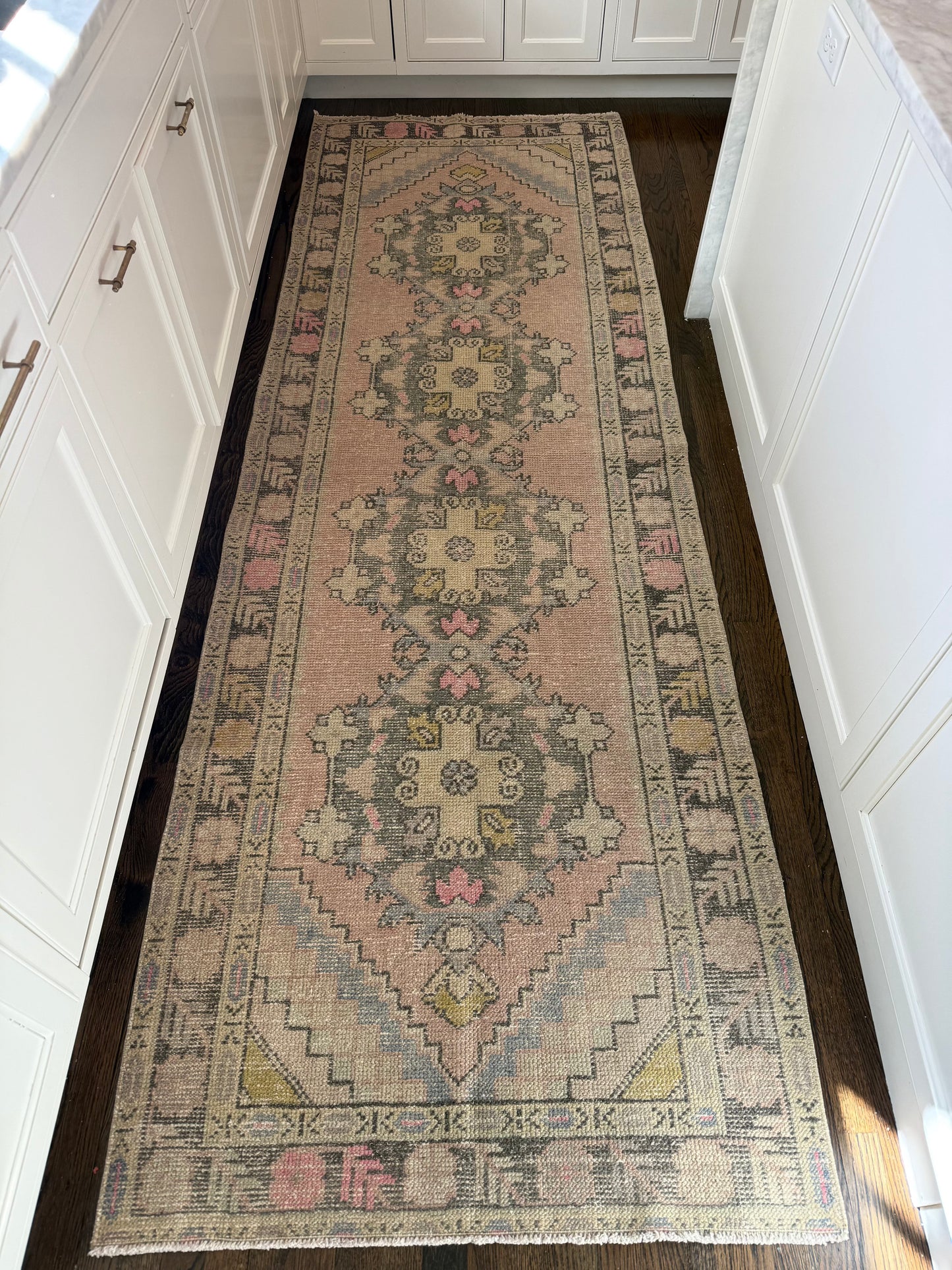 3’4” x 10’1” vintage runner with pink, grey, blue, and yellow patterns.