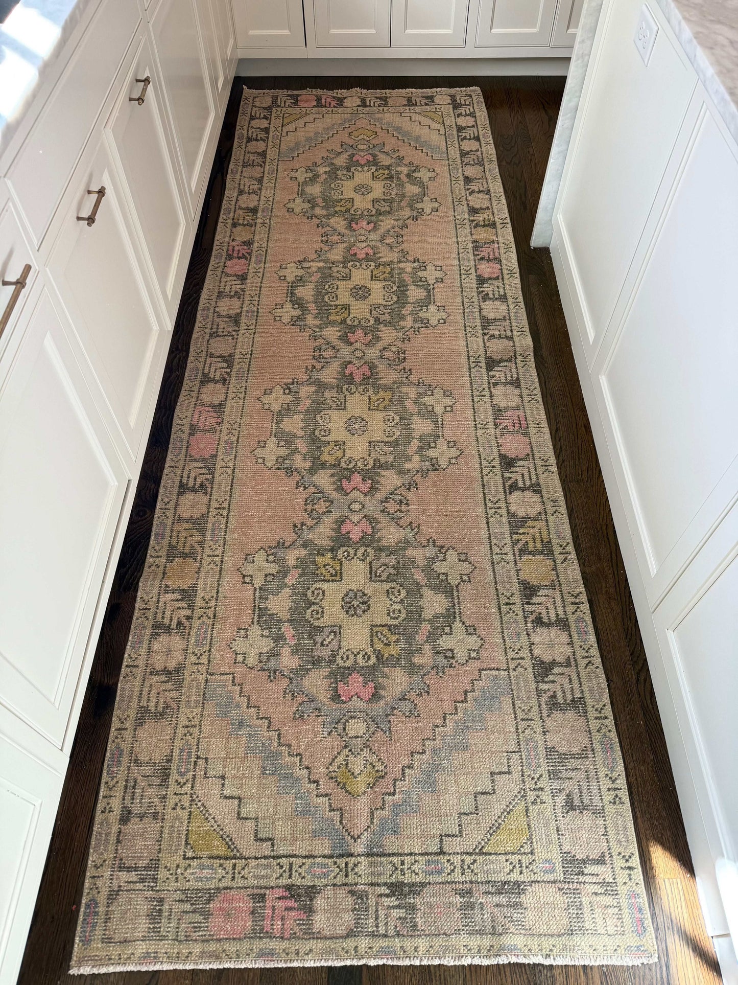 3’4” x 10’1” vintage runner with pink, grey, blue, and yellow patterns.