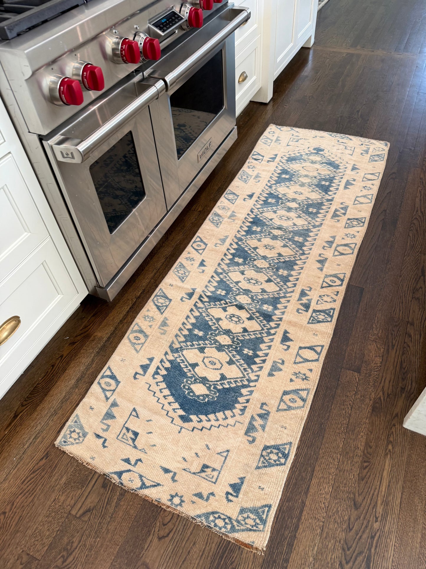 Blue and white 2’4” x 6’10” runner rug with classic design in a kitchen setting.