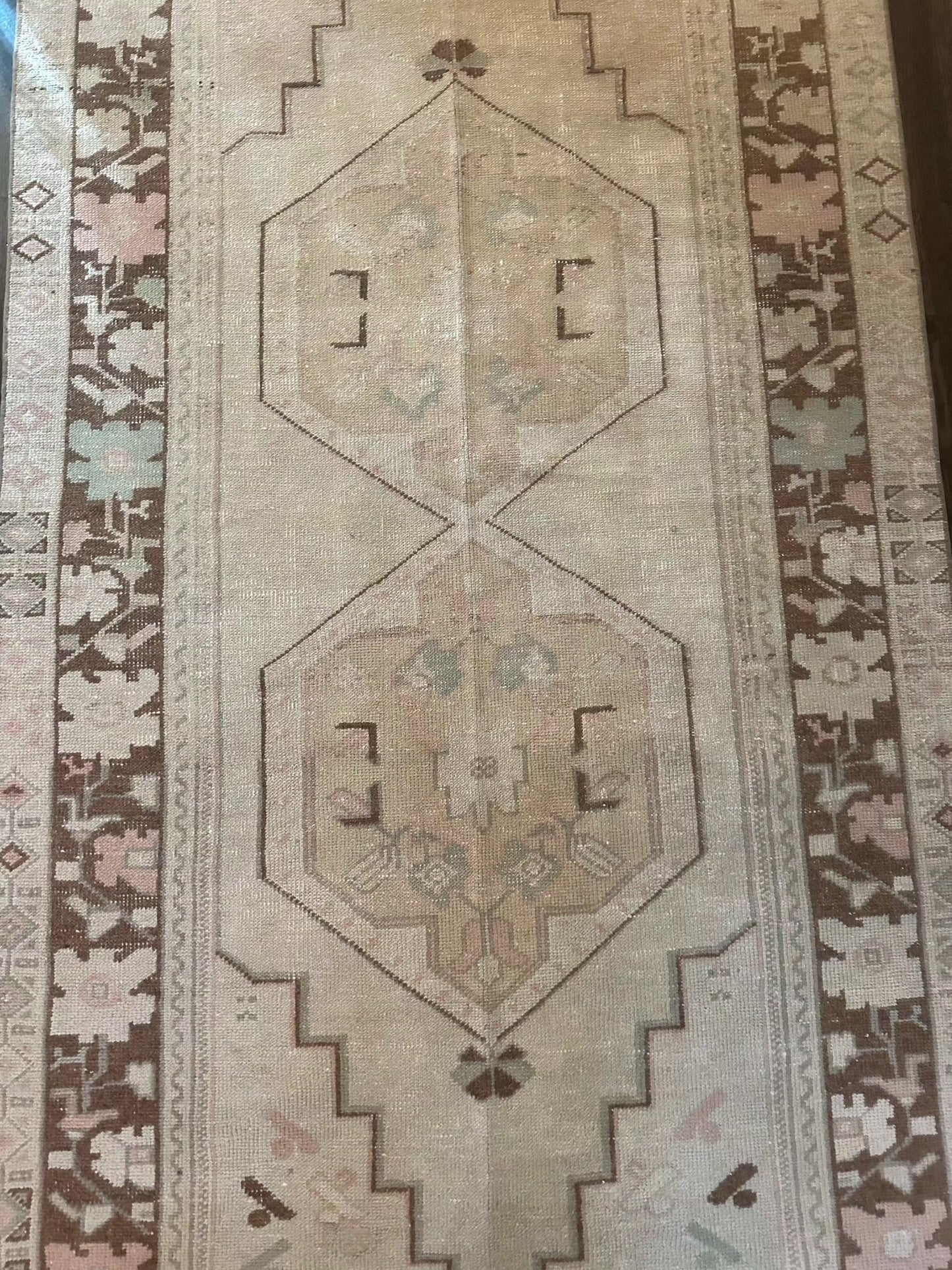 3’10” x 8’2” area rug with brown border and geometric pattern