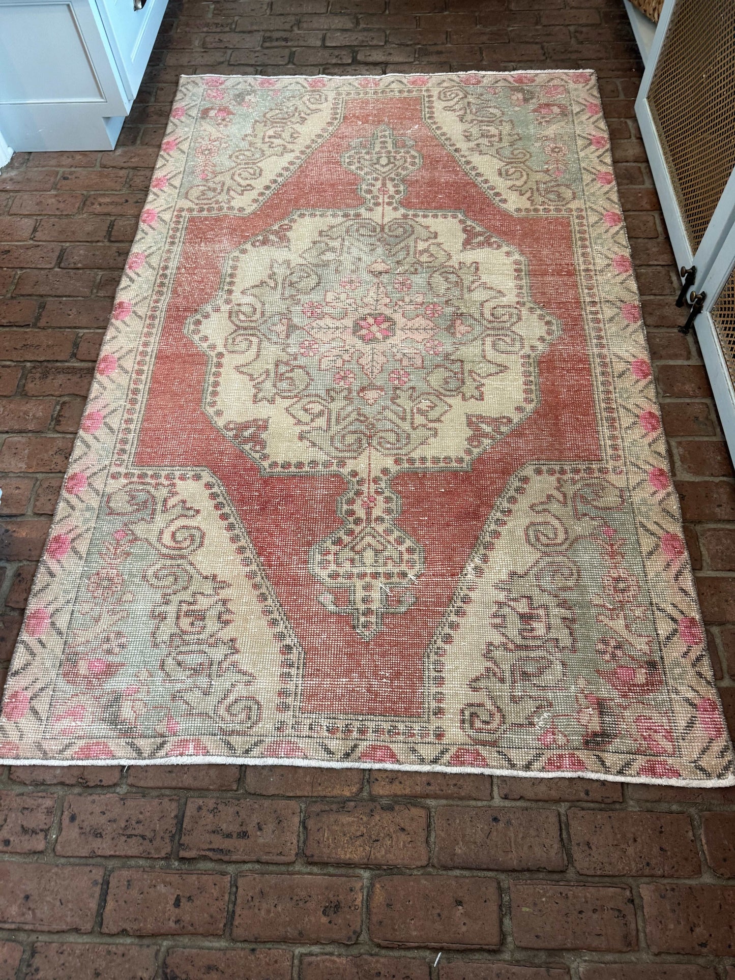 4'3" x 6'8" area rug with classic medallion in rust red, blue, gray, and pink