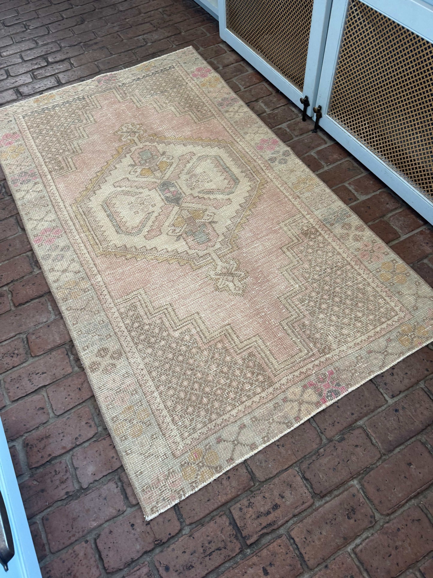 Rug with geometric pattern on a brick floor