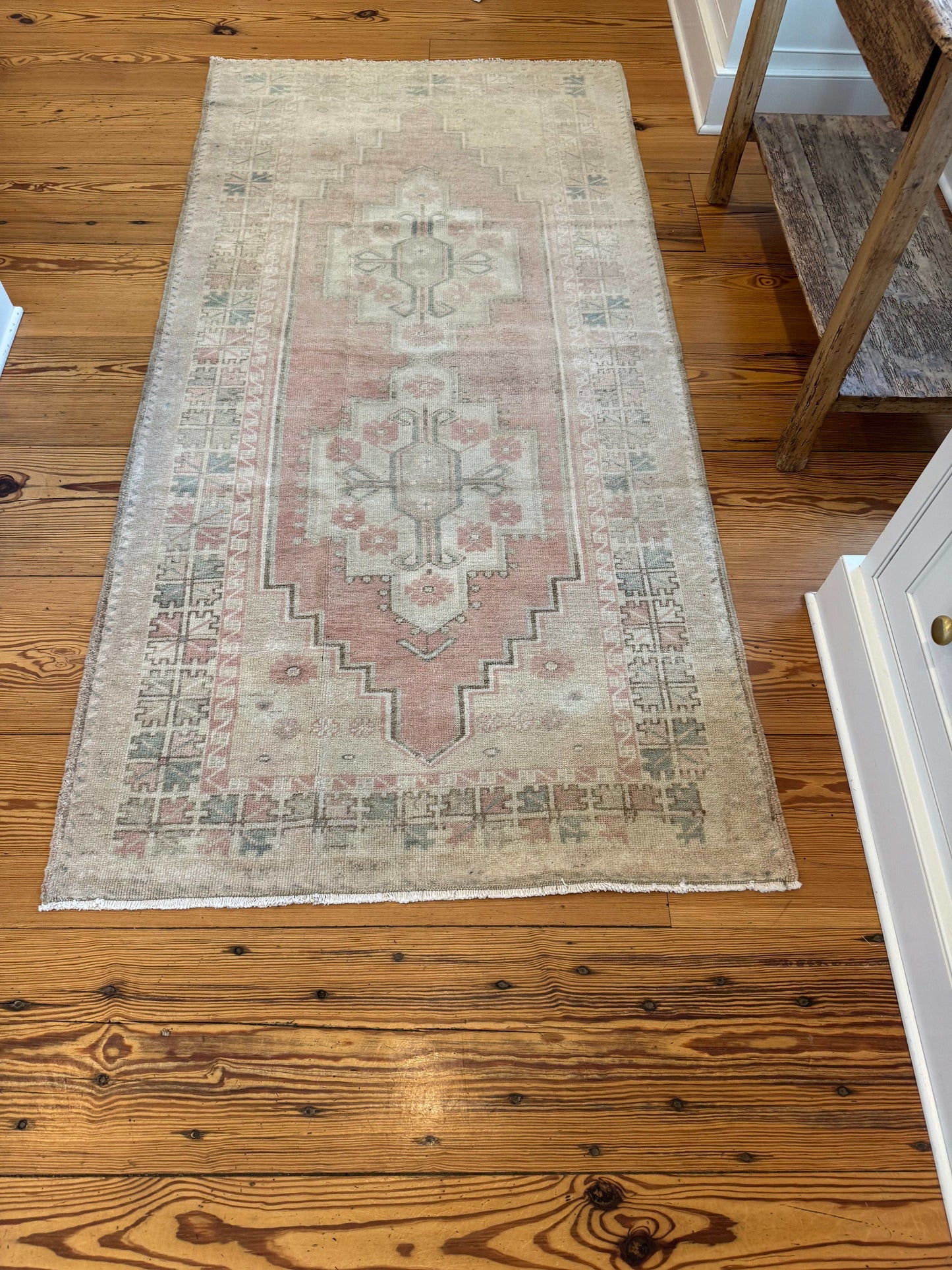 3'5" x 7' area rug with soft red and beige double center medallion design