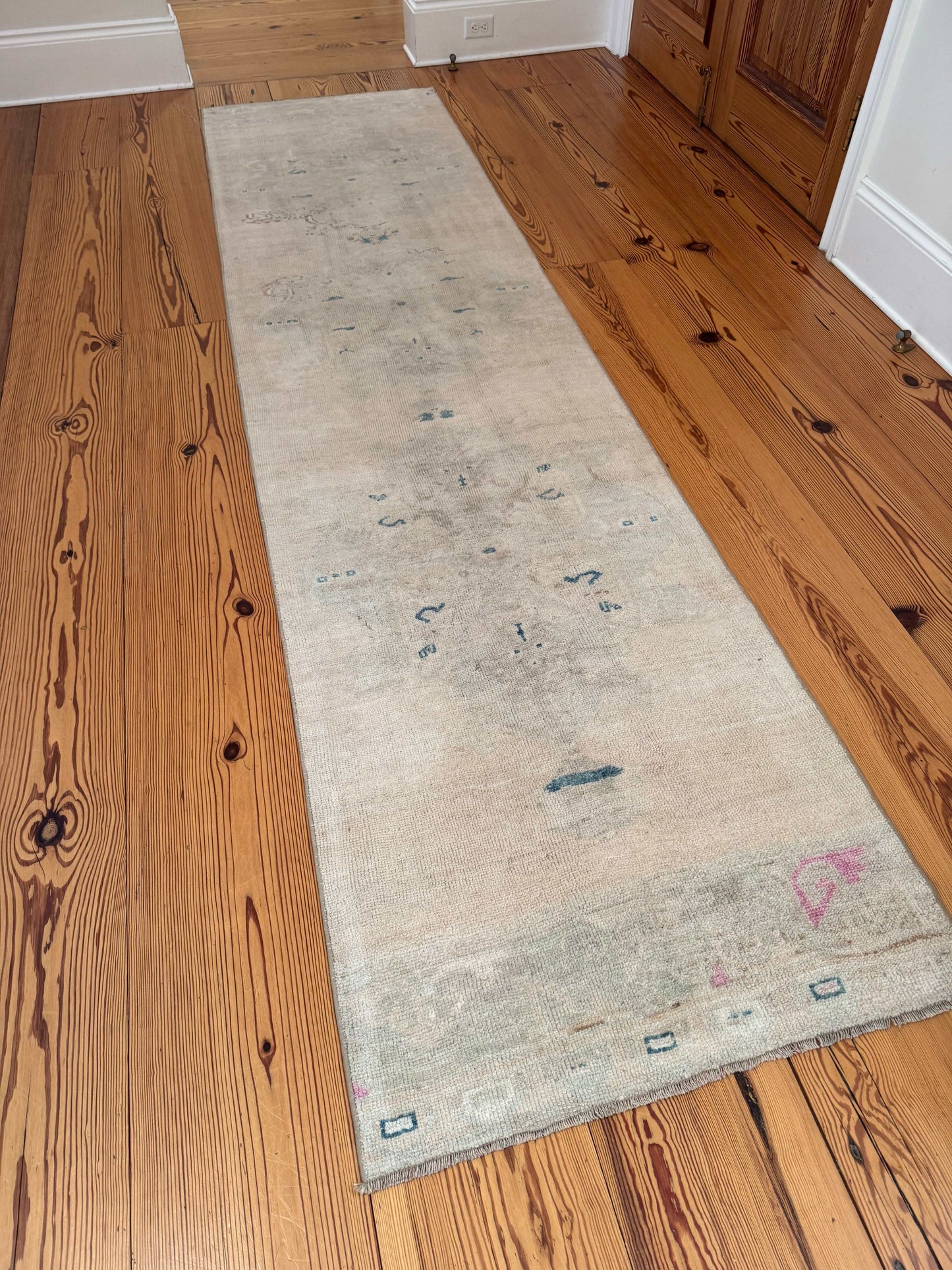 2'11" x 11'11" long neutral runner rug with beige, gray, blue, and pink accents