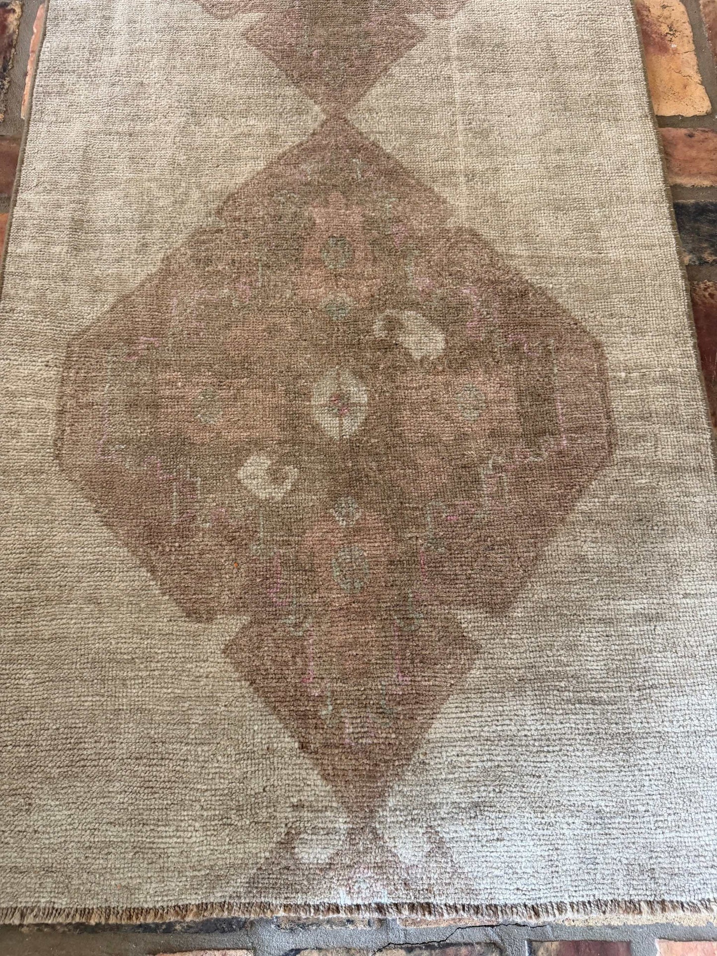 2'7" x 8'8" hand-knotted Turkish runner rug with brown and beige background and pink medallion center designs