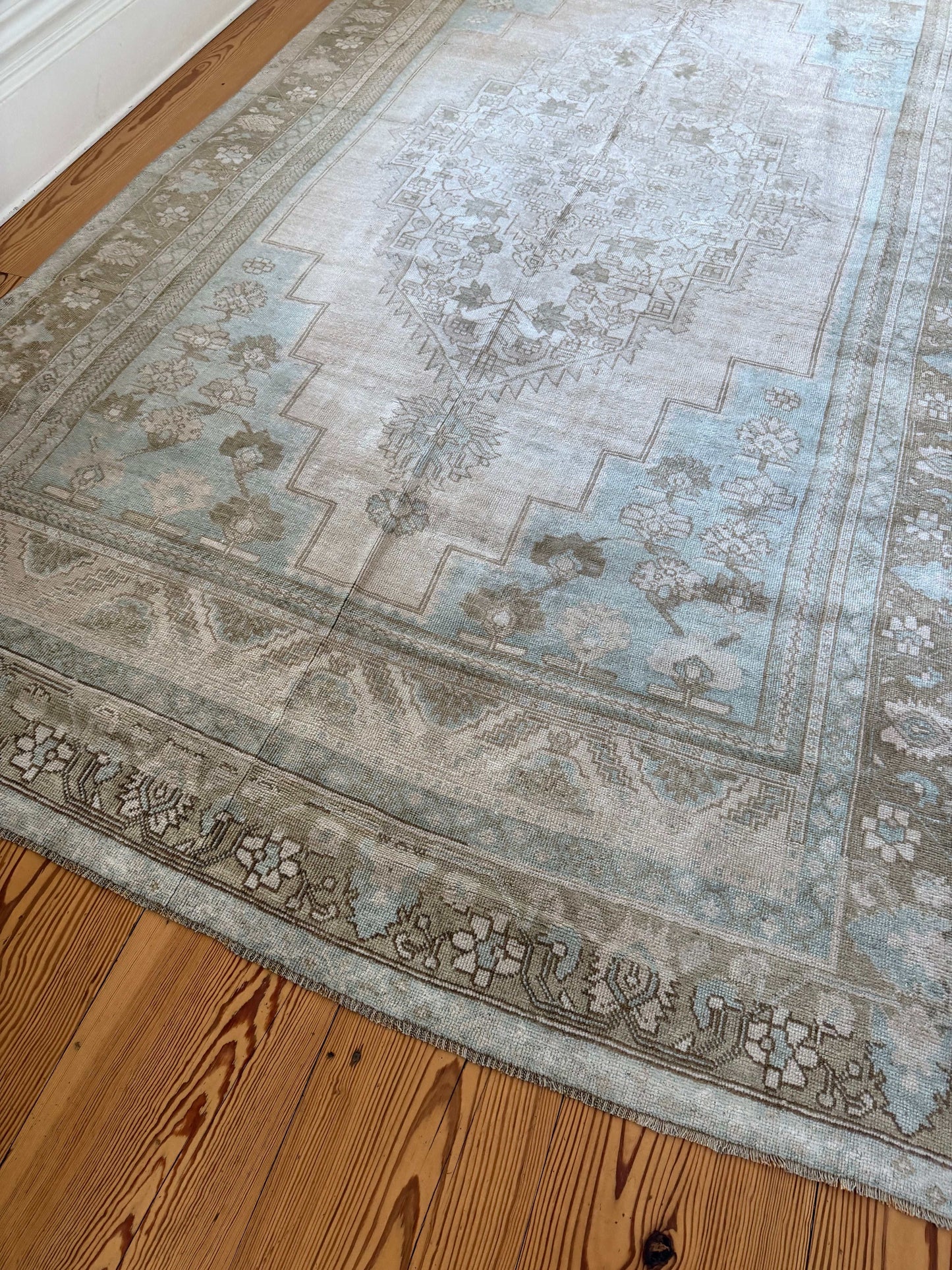 Decorative rug with floral patterns on a wooden floor