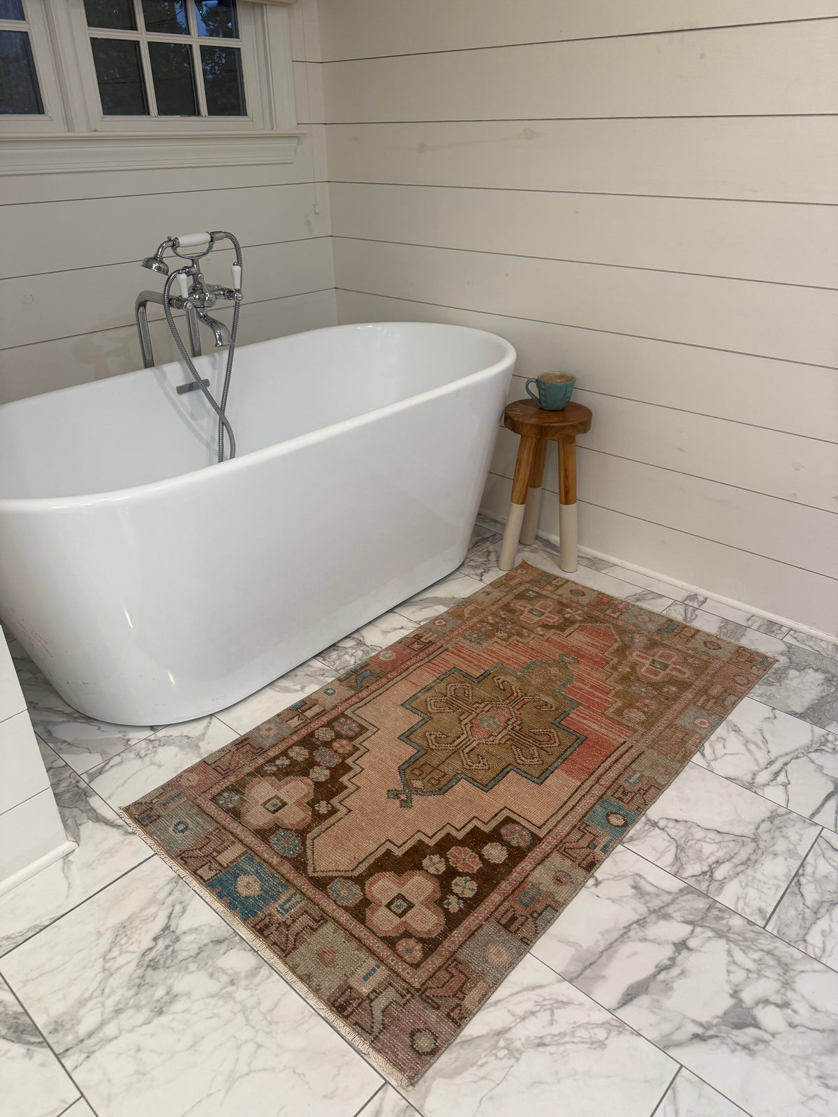 Vintage Rug with faded terracotta and blush wool, featuring an intricate central medallion and turquoise floral border