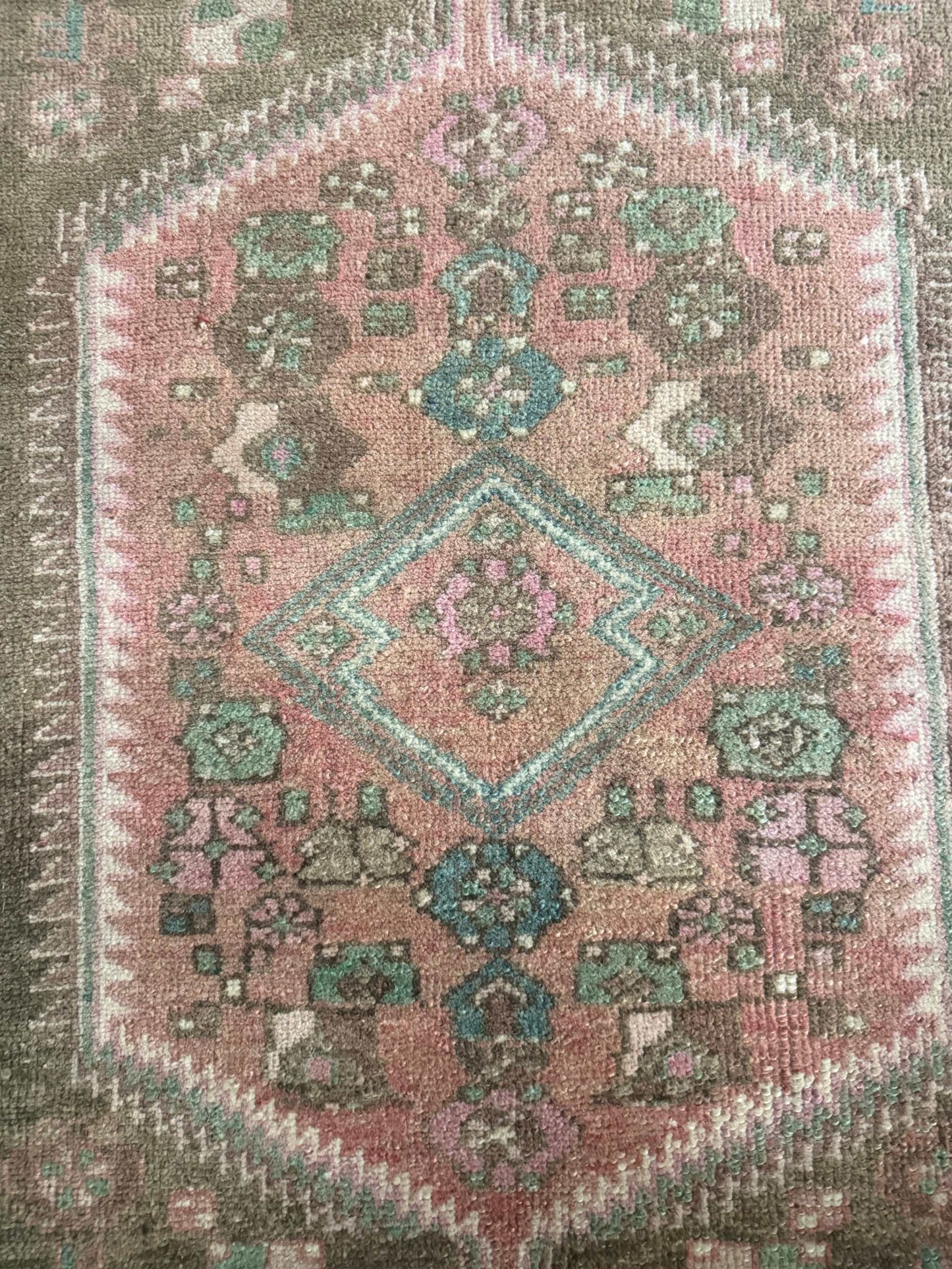 3’9”x6’7” colorful Turkish area rug with reds, pinks, blues, brown, and cream accents