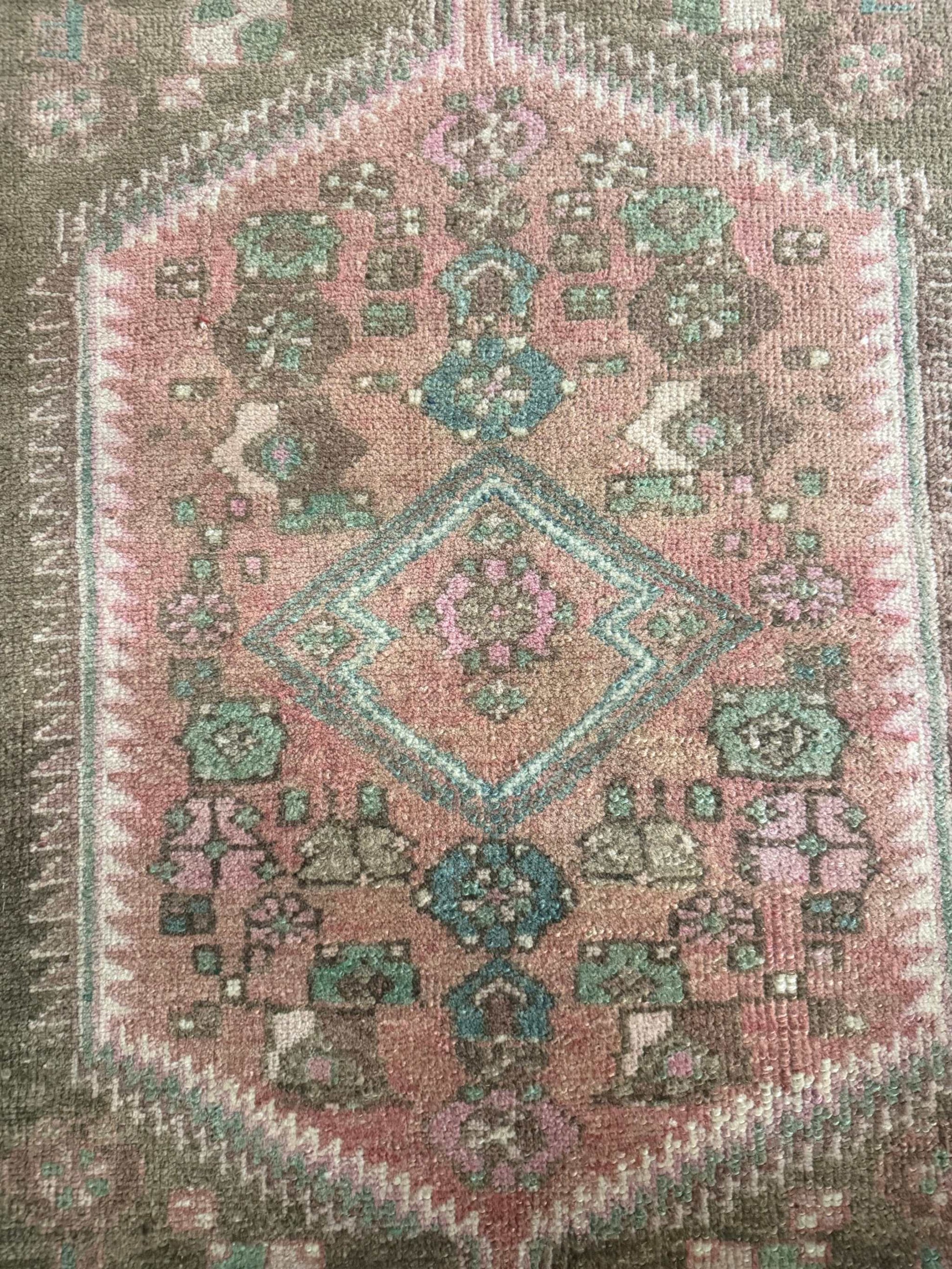 3’9”x6’7” colorful Turkish area rug with reds, pinks, blues, brown, and cream accents