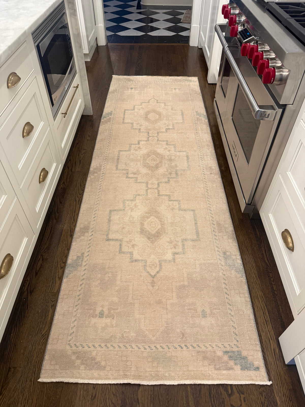 2’11” x 9’1” Runner in neutral beige with faded blue geometric patterns and a distressed vintage finish