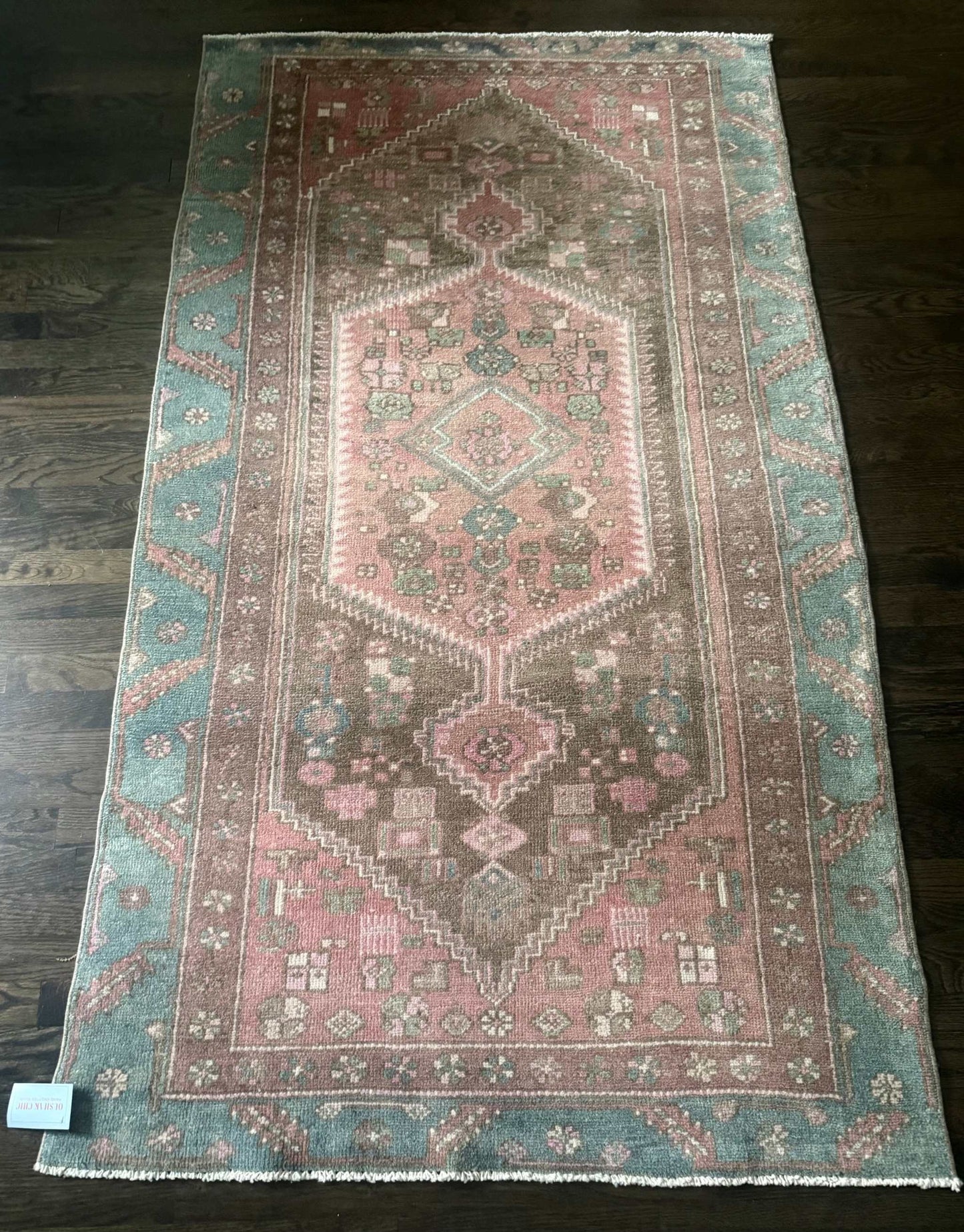 3’9”x6’7” colorful Turkish area rug with reds, pinks, blues, brown, and cream accents