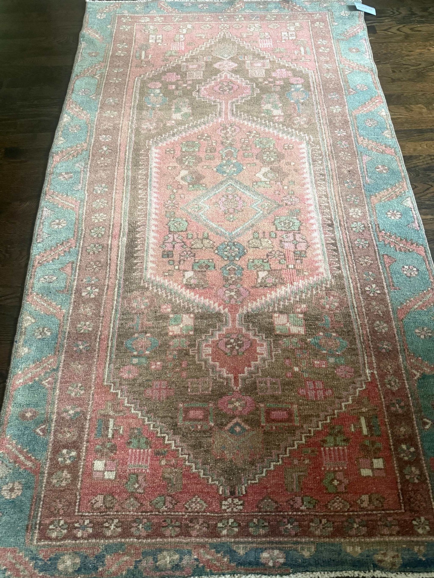 3’9”x6’7” colorful Turkish area rug with reds, pinks, blues, brown, and cream accents