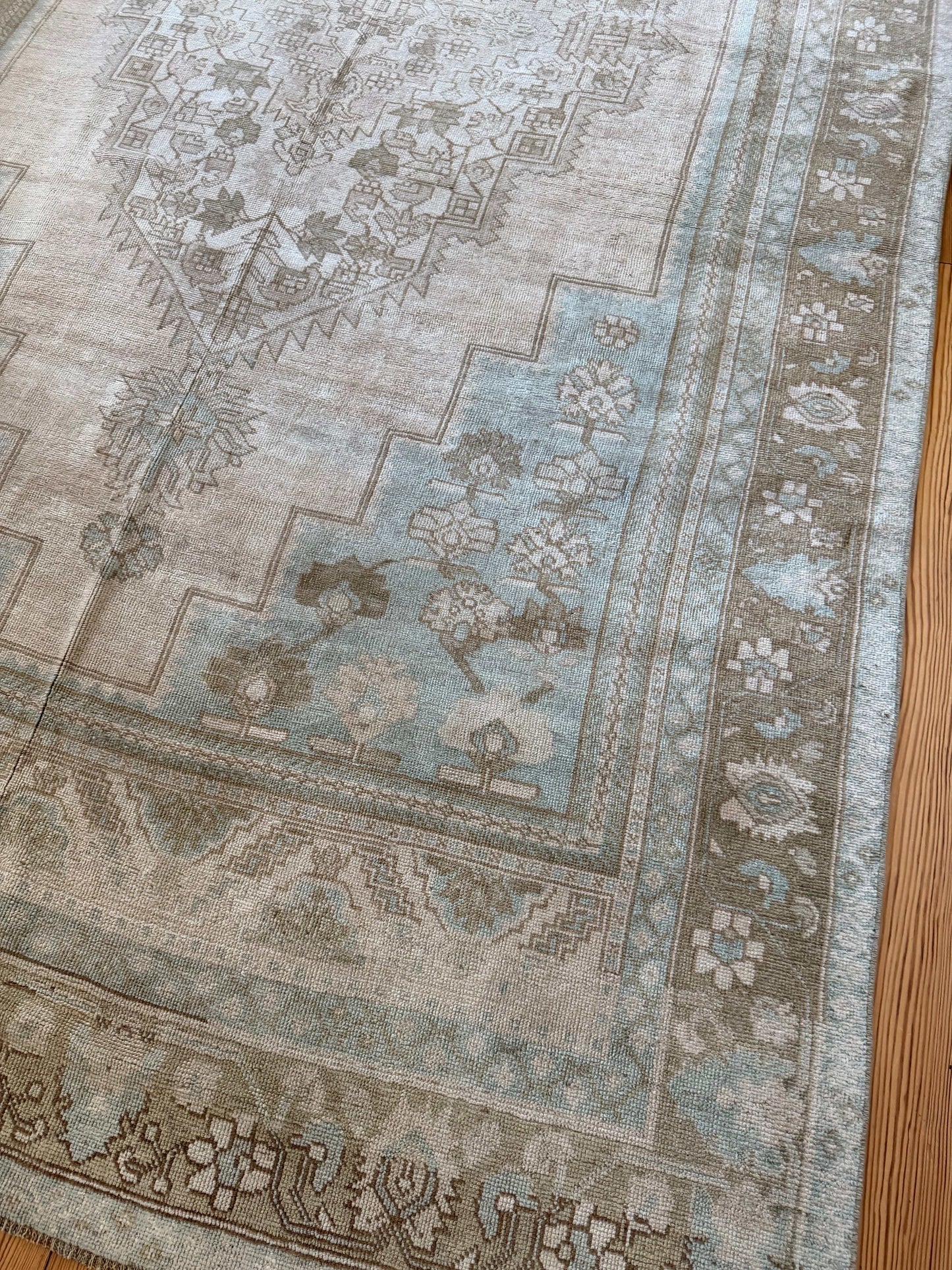 Close-up of a patterned rug on a wooden floor