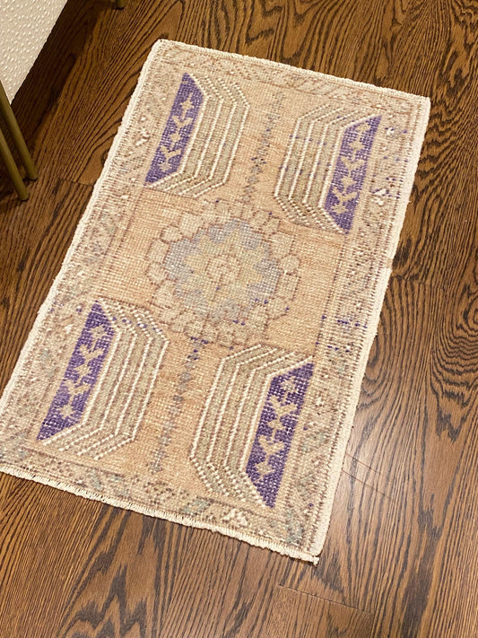 1’8”x2’7” Oushak Mat in light beige, purple, and blue.