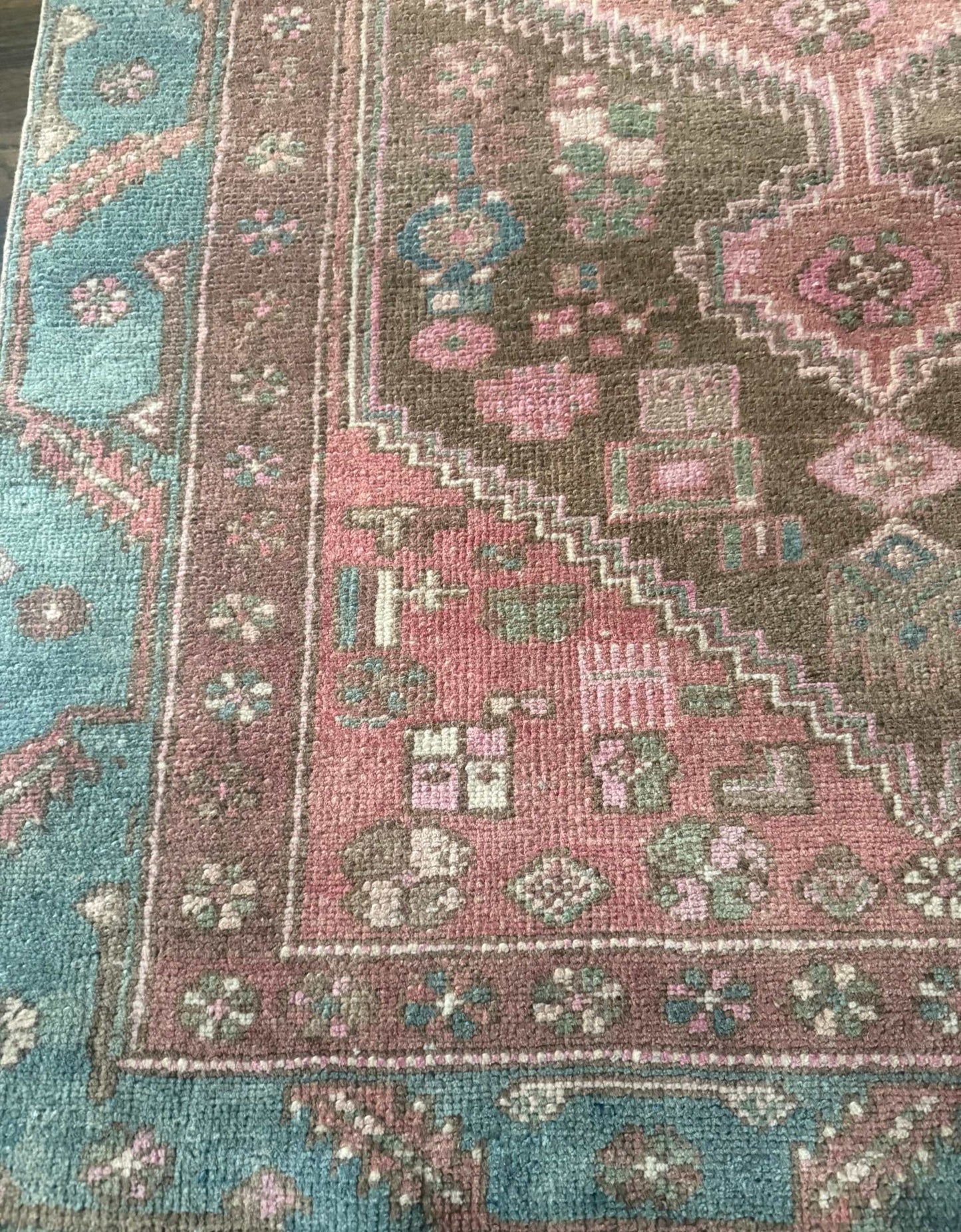 3’9”x6’7” colorful Turkish area rug with reds, pinks, blues, brown, and cream accents