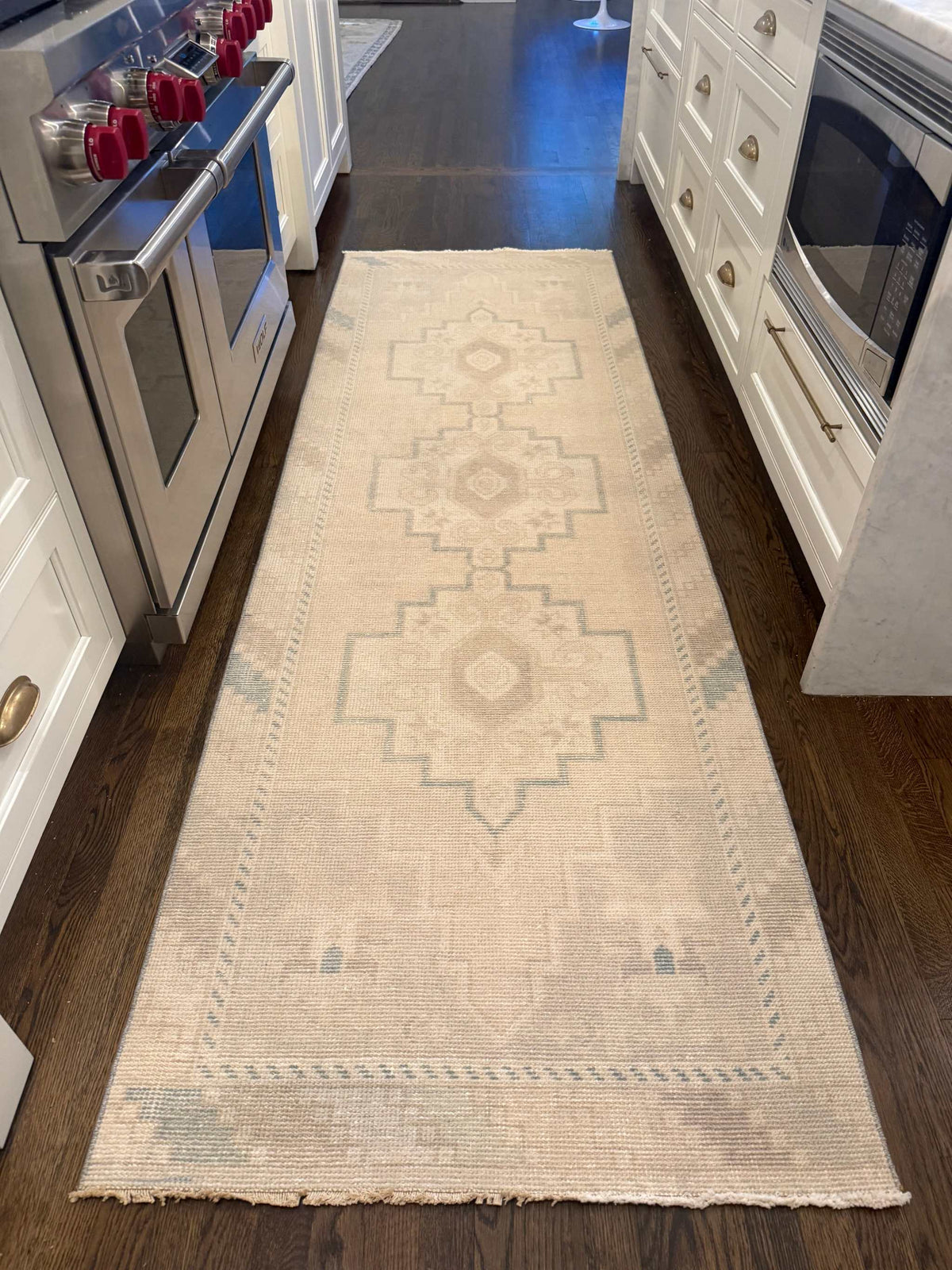 2’11” x 9’1” Runner in neutral beige with pale blue geometric patterns and a fringed edge