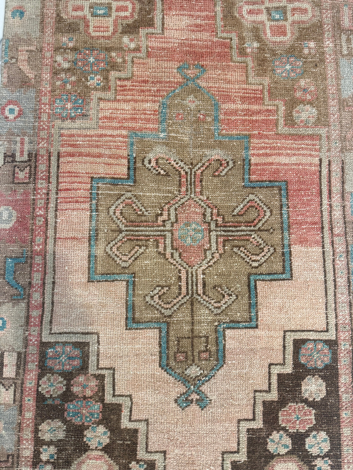 Vintage Rug with hand-knotted wool, faded blush and terracotta field, olive medallion, and turquoise motifs