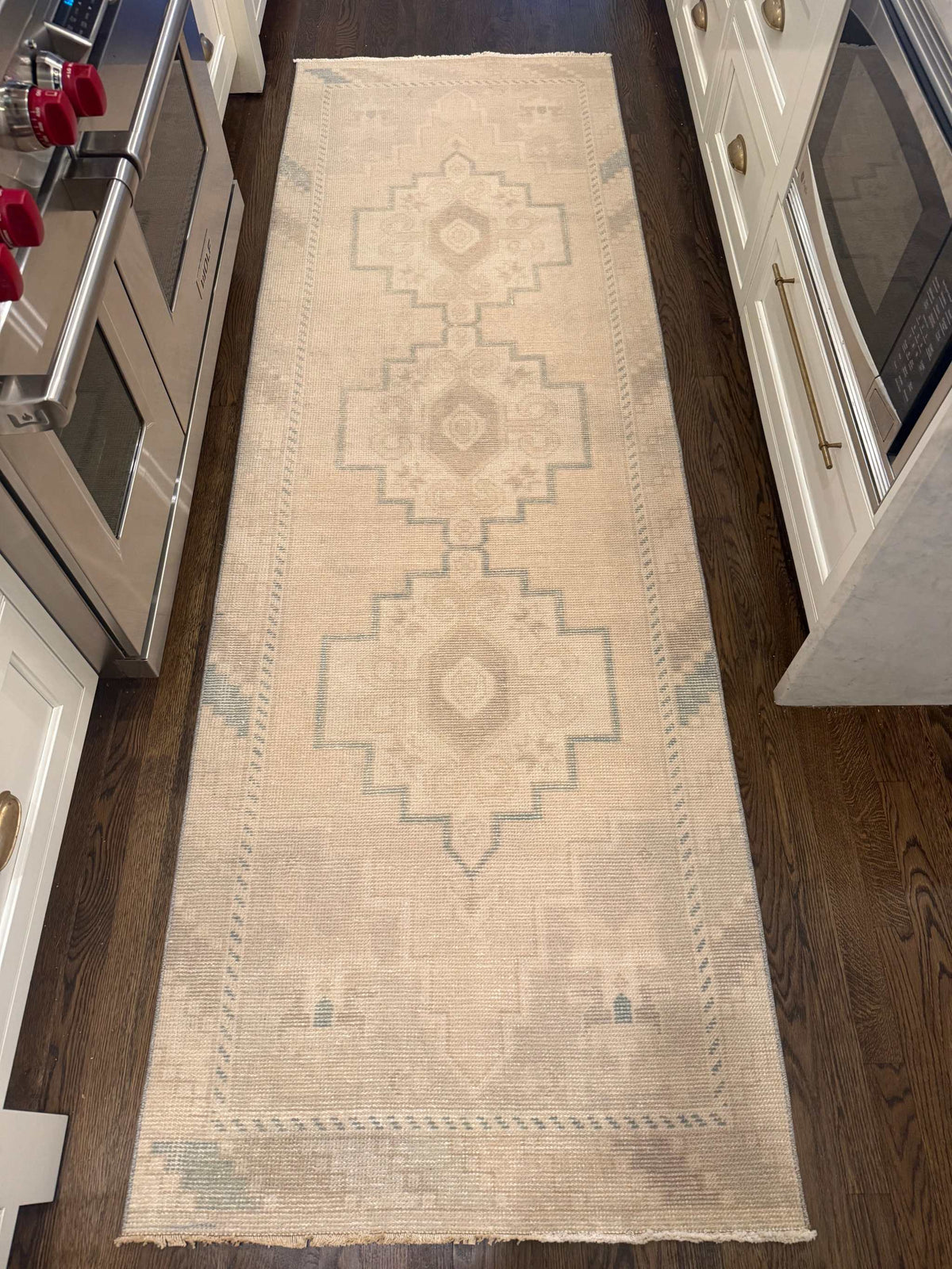 2’11” x 9’1” Runner, neutral ivory rug with faded blue geometric medallion pattern and fringed ends