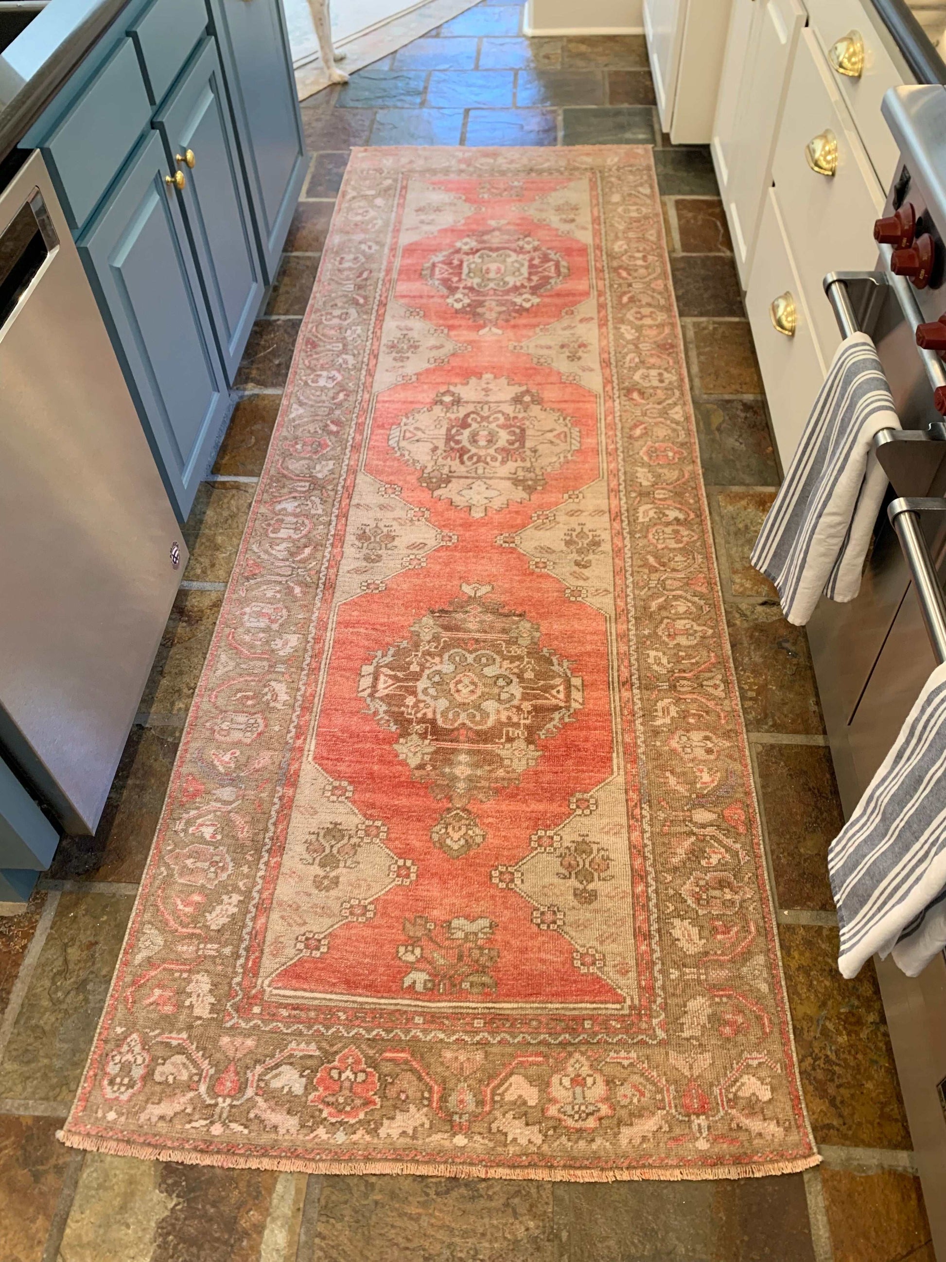3’3”x9’9” Vintage Oushak runner in red, grey, and brown pattern.