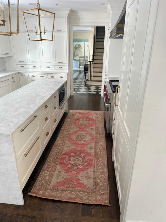 3’3”x9’9” Vintage Oushak runner with red, grey, and brown hues in a modern kitchen hallway