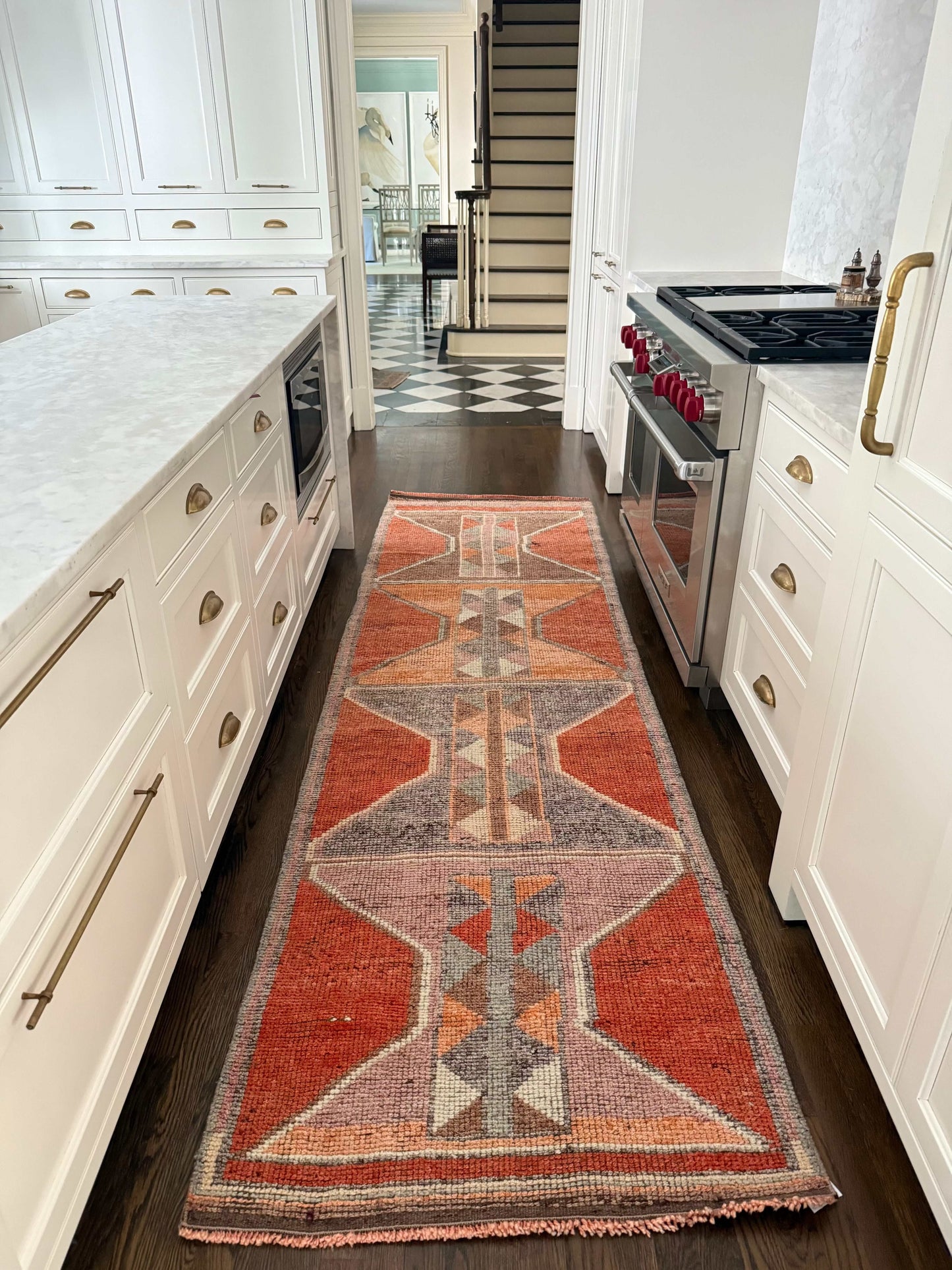 3' x 10'1" rug runner with bold orange and gray geometric pattern on hardwood floor in modern kitchen