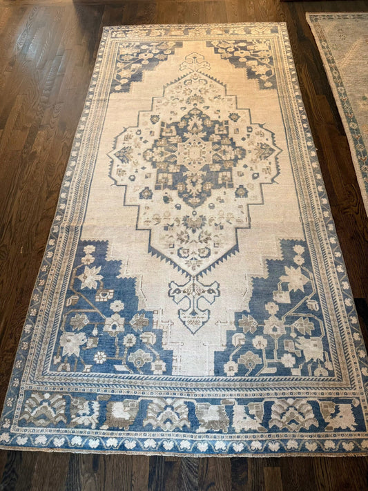 4’9” x 9’9” vintage Turkish area rug with blue, white, and gray tones