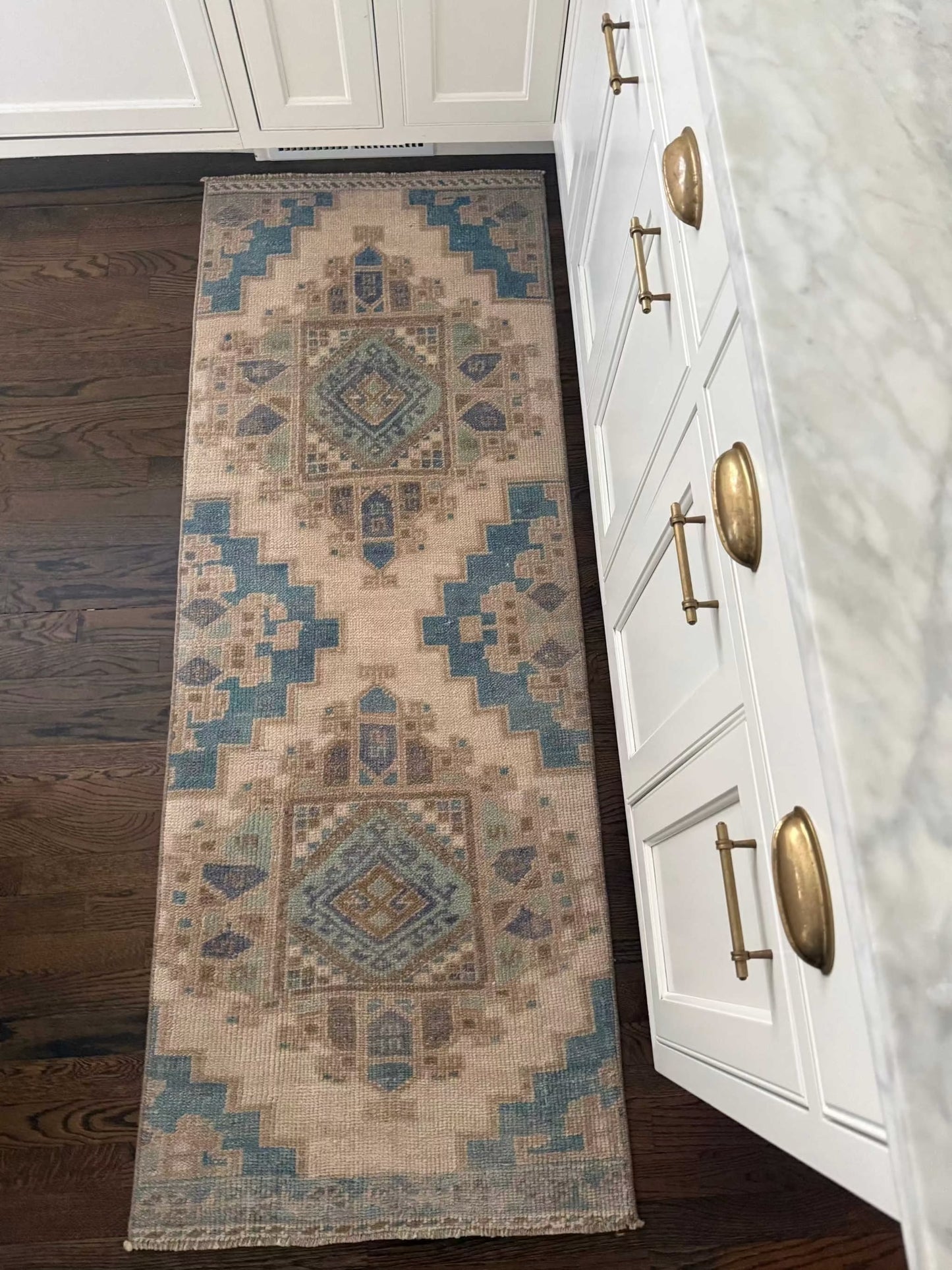 2’3”x6’2” runner rug with blues, greens, and lavender colors.