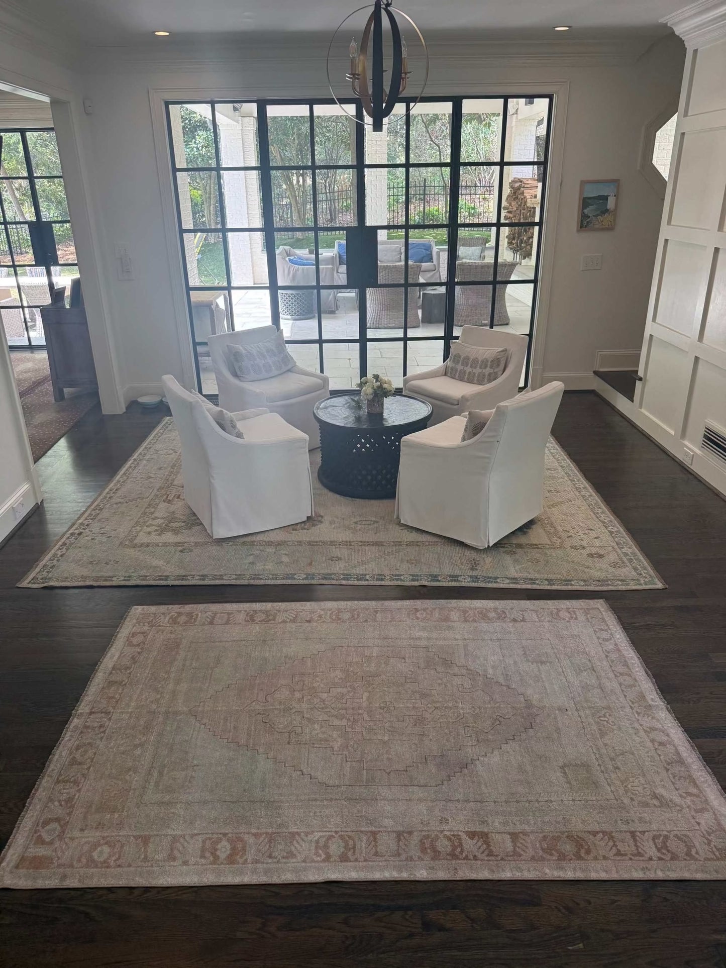 4’7” x 7’3” vintage area rug with subtle light blues, beige, grey, brown, soft greens, and muted yellows