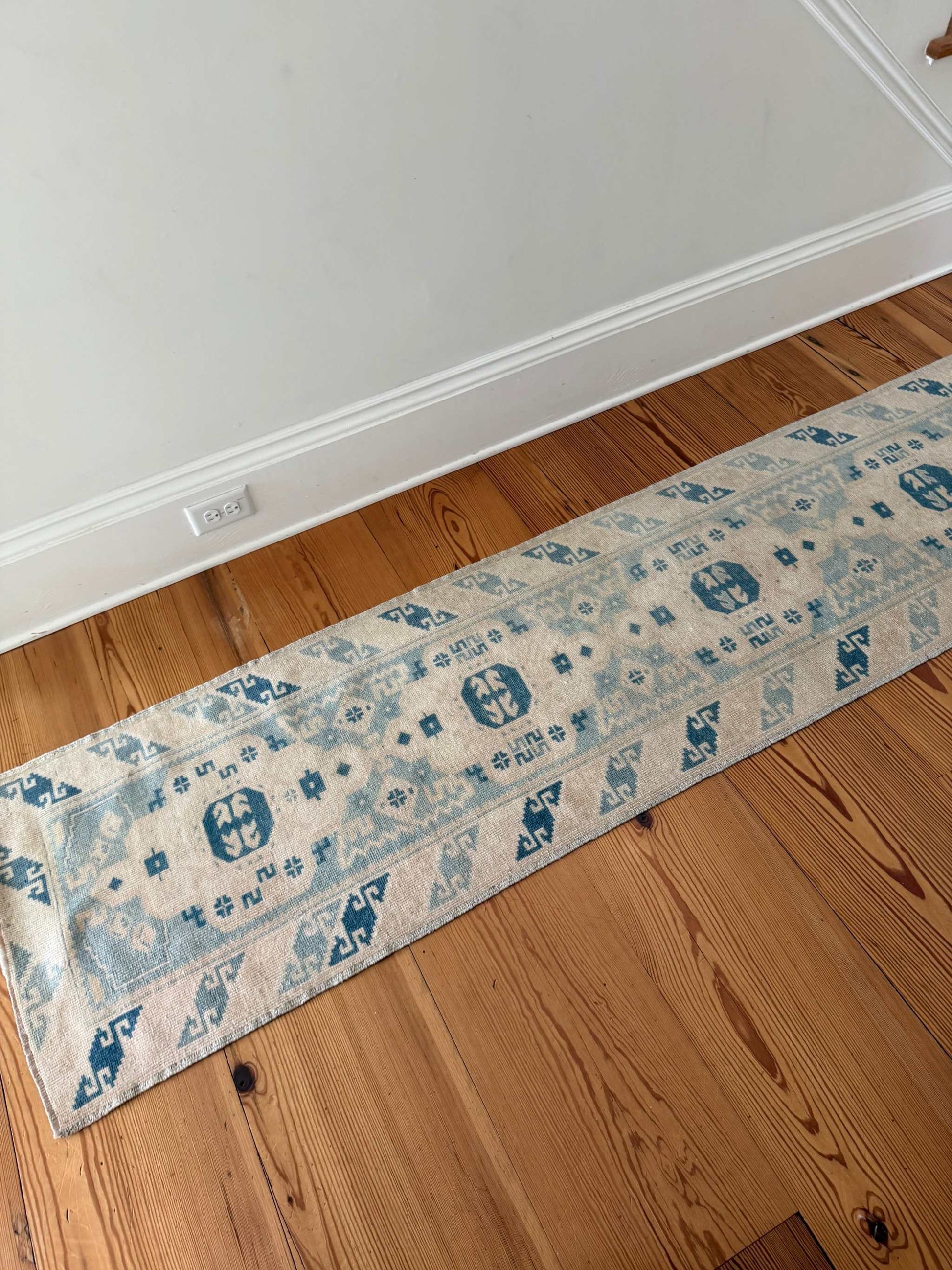 2' x 9'3" narrow runner with rich blues and creamy ivory tones in a vintage hand-knotted design