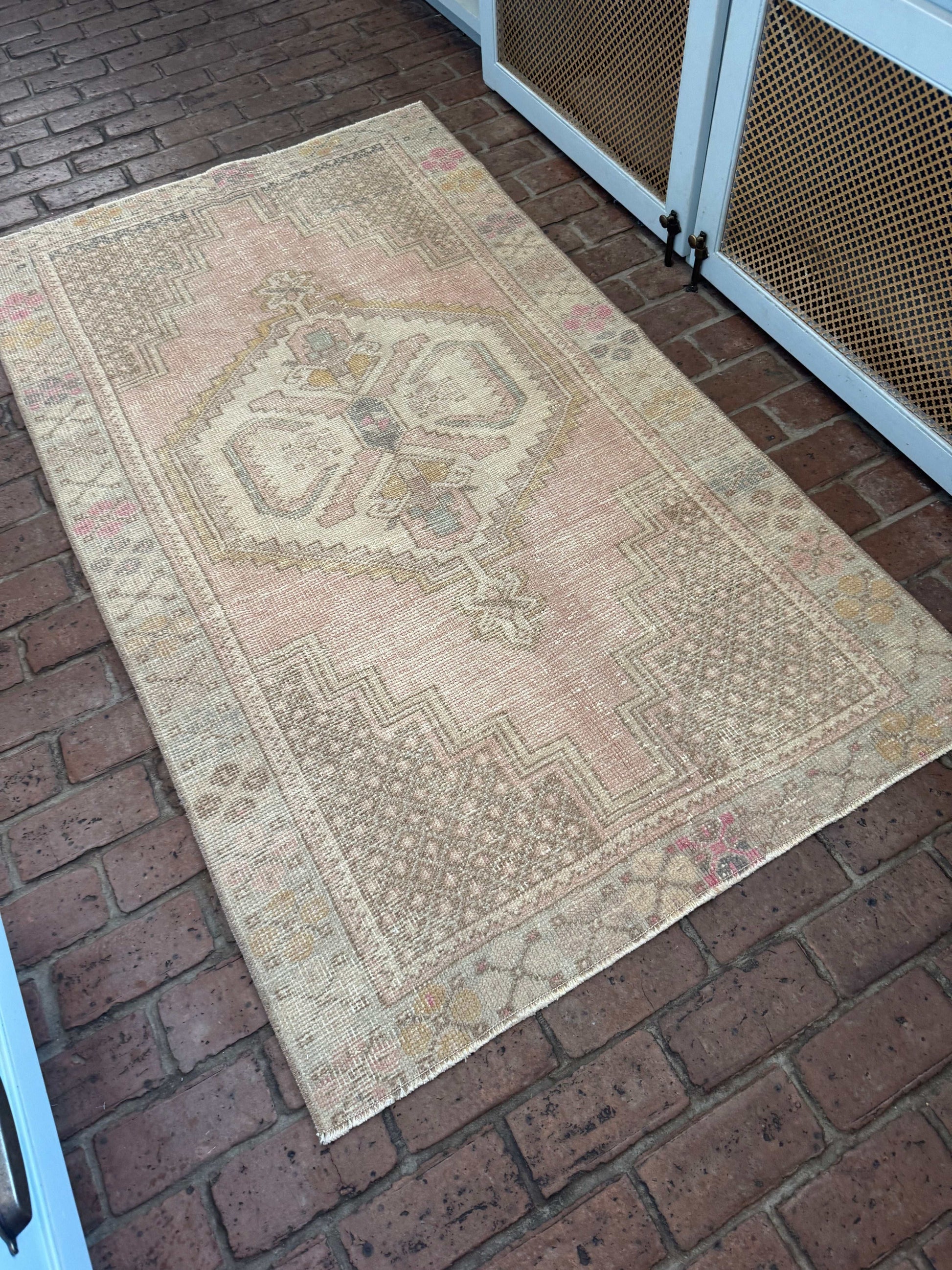 Rug with geometric pattern on a brick floor