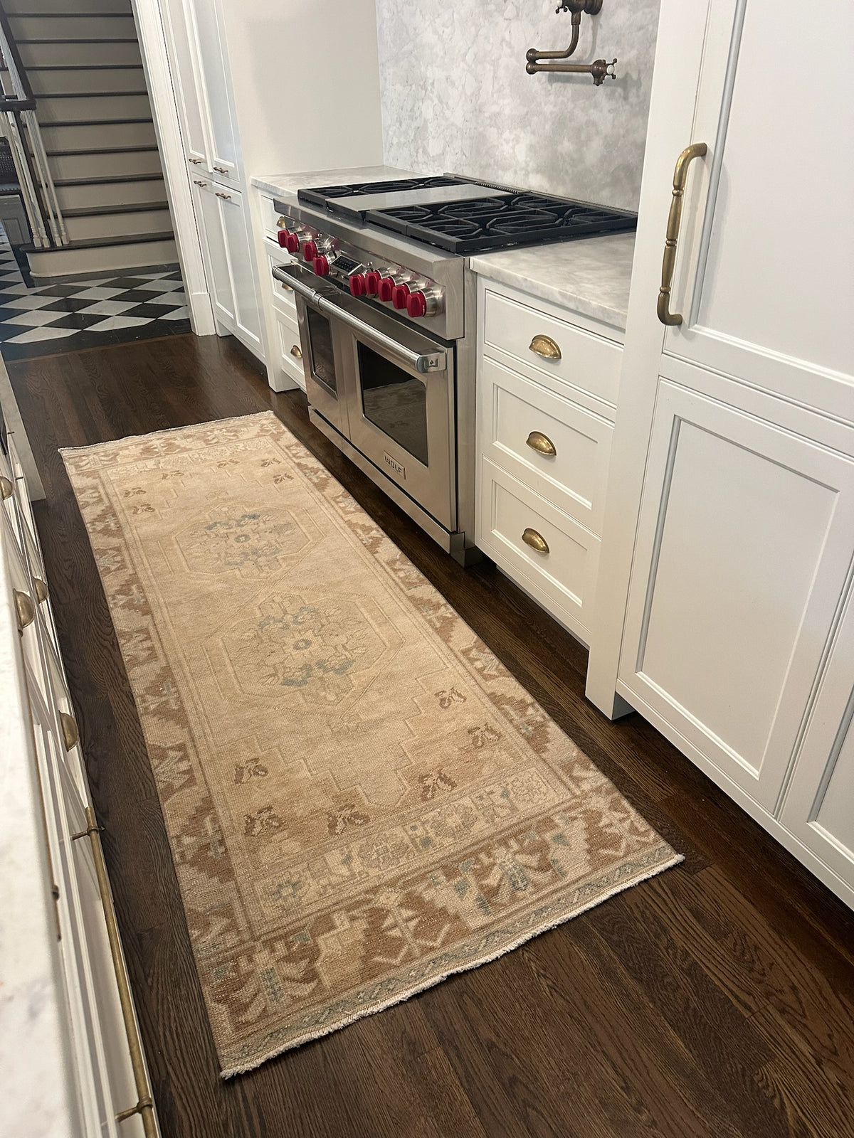 brown and tan rug runner in a kitchen