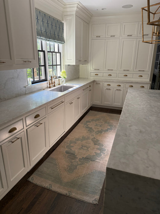 3’1” x 9’10” runner rug with neutrals, soft blues, soft green, and ivory accents in a kitchen setting