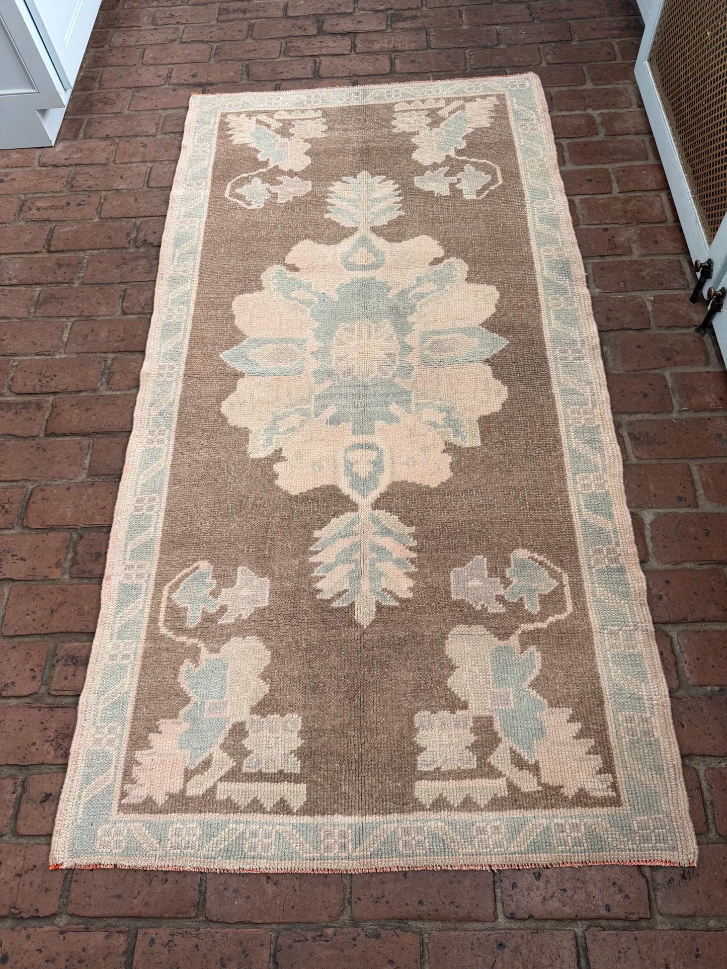 3'1" x 6'1" hand-knotted rug with brown background and taupe blue designs