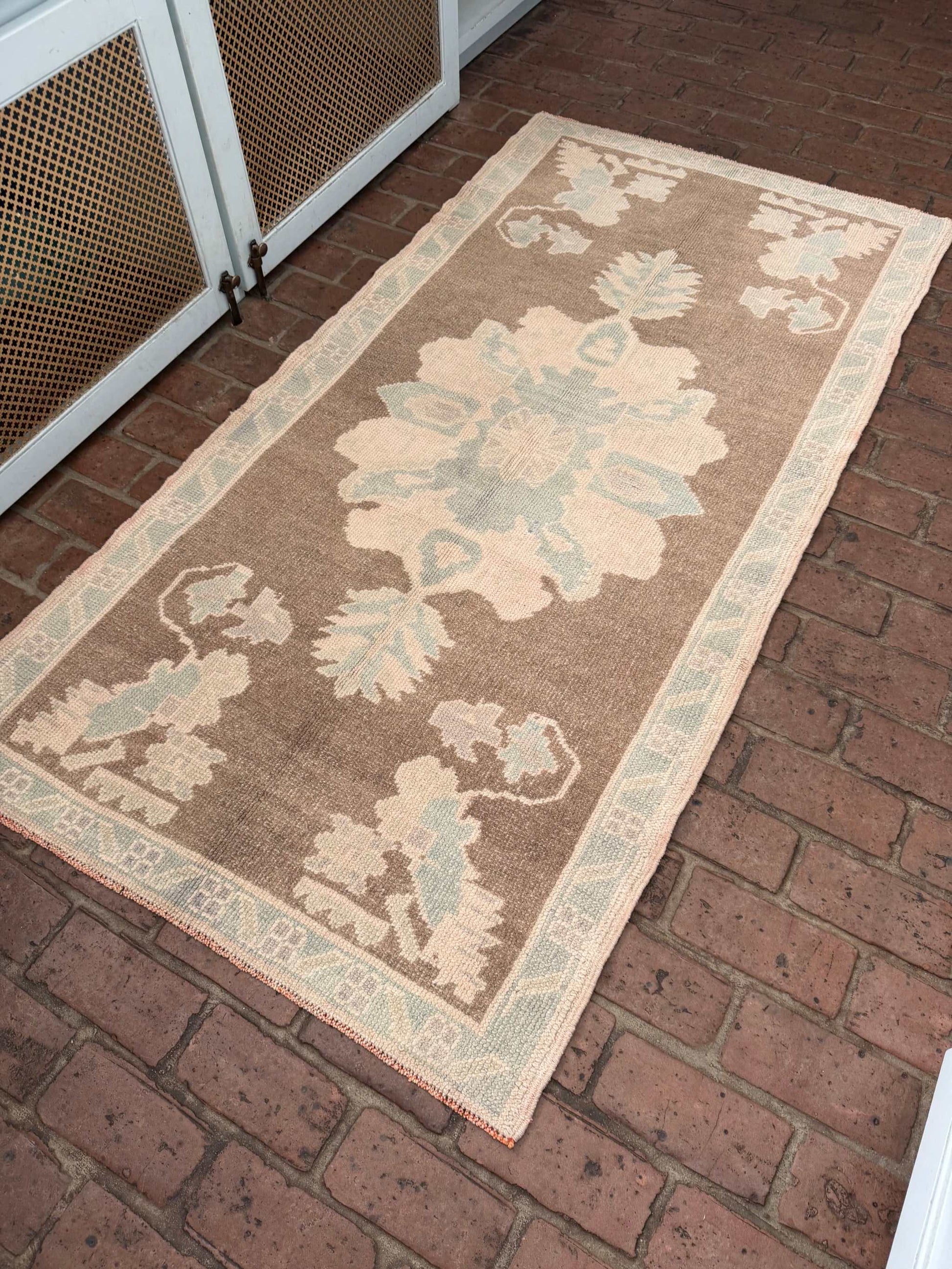 3'1" x 6'1" hand knotted runner rug with brown background and taupe blue designs
