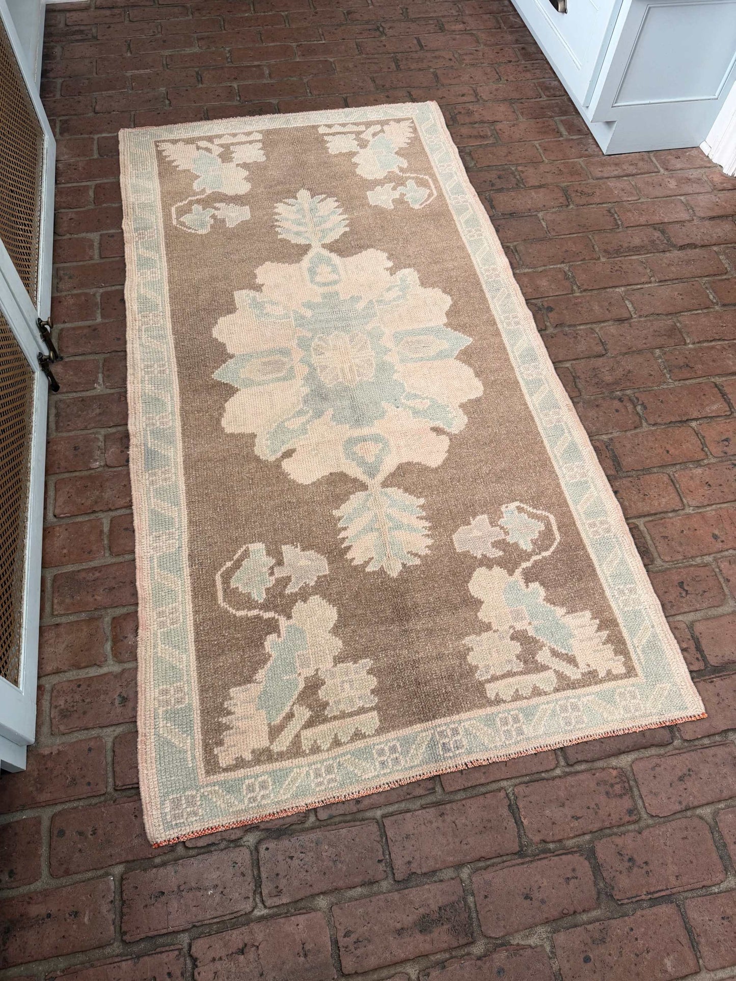 3'1" x 6'1" hand knotted runner rug with brown background and taupe blue designs