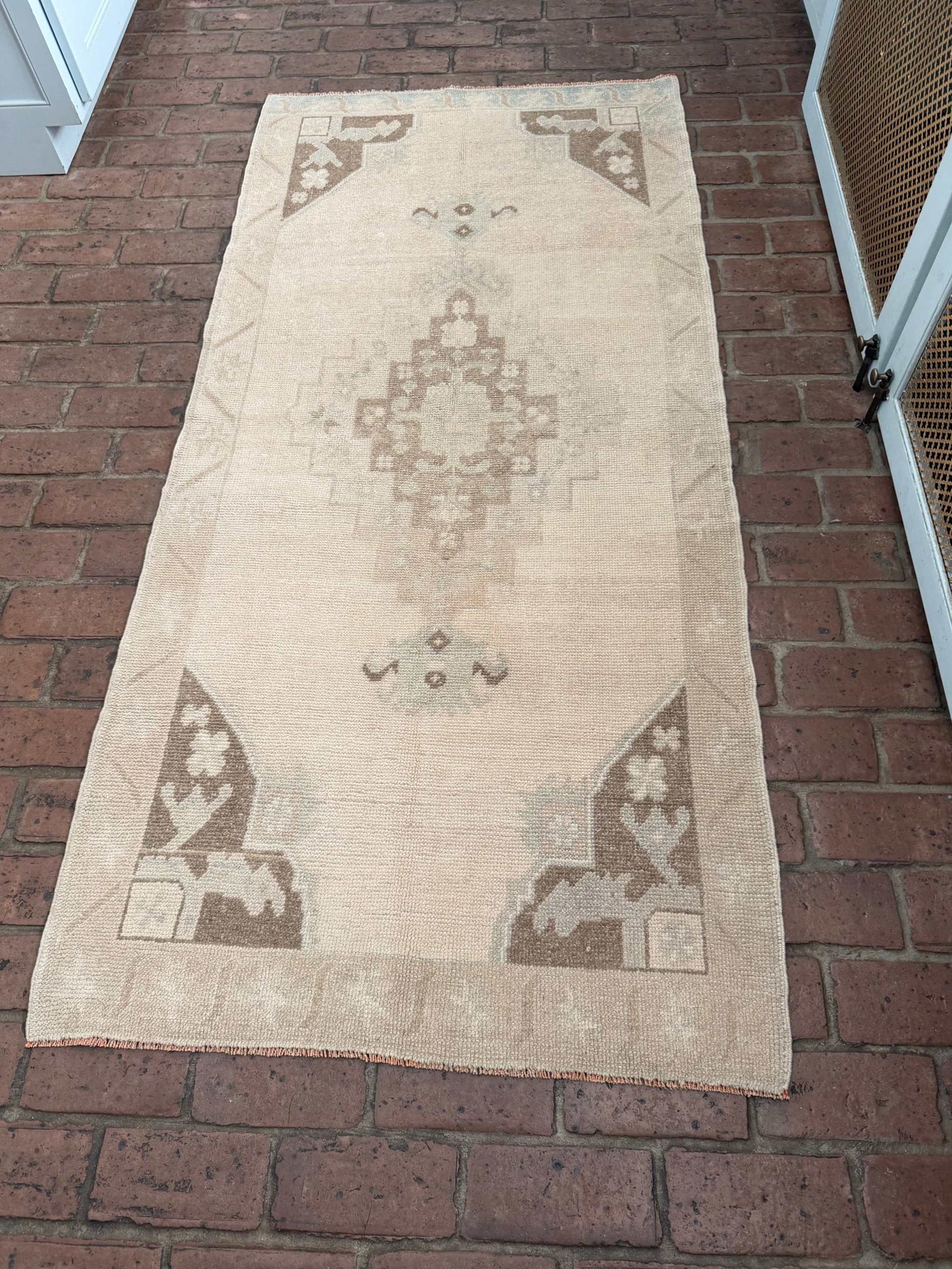 Hand knotted Turkish rug with taupe, brown, and blue center medallion design, 2'11" x 6'5"
