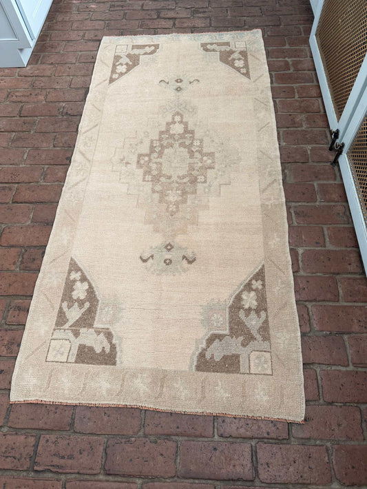 Hand knotted Turkish rug with taupe, brown, and blue center medallion design, 2'11" x 6'5"
