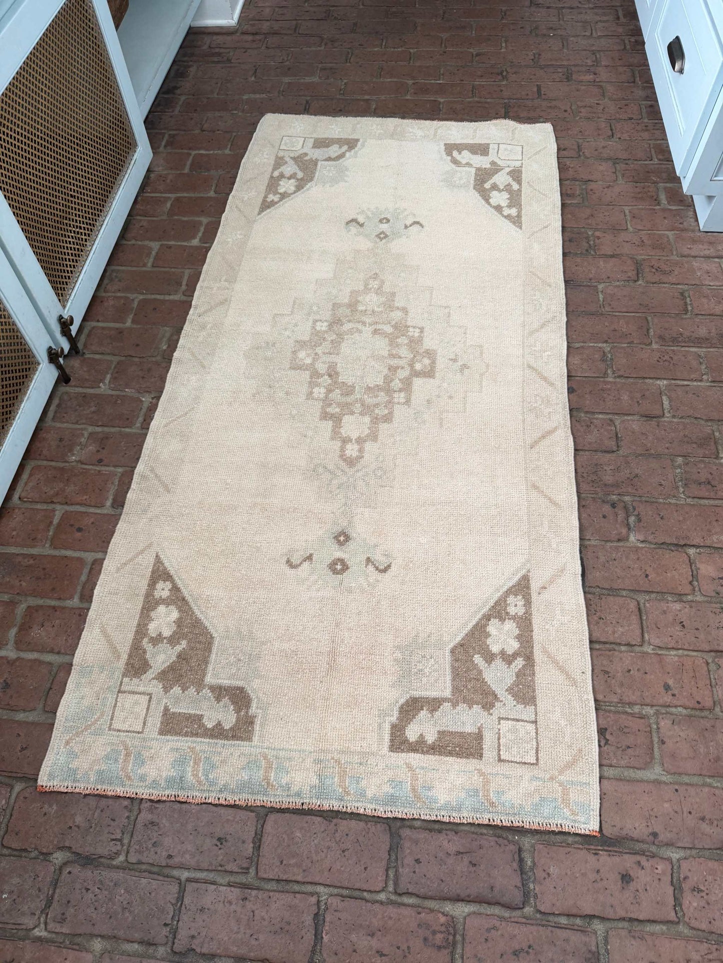 Hand knotted Turkish rug with taupe, brown, and blue classic center medallion design measuring 2'11" x 6'5"