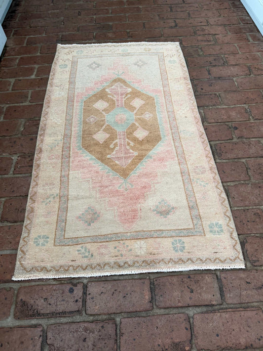 Small colorful area rug 2'4" x 4'3" with pink, blue, and brown center medallion design
