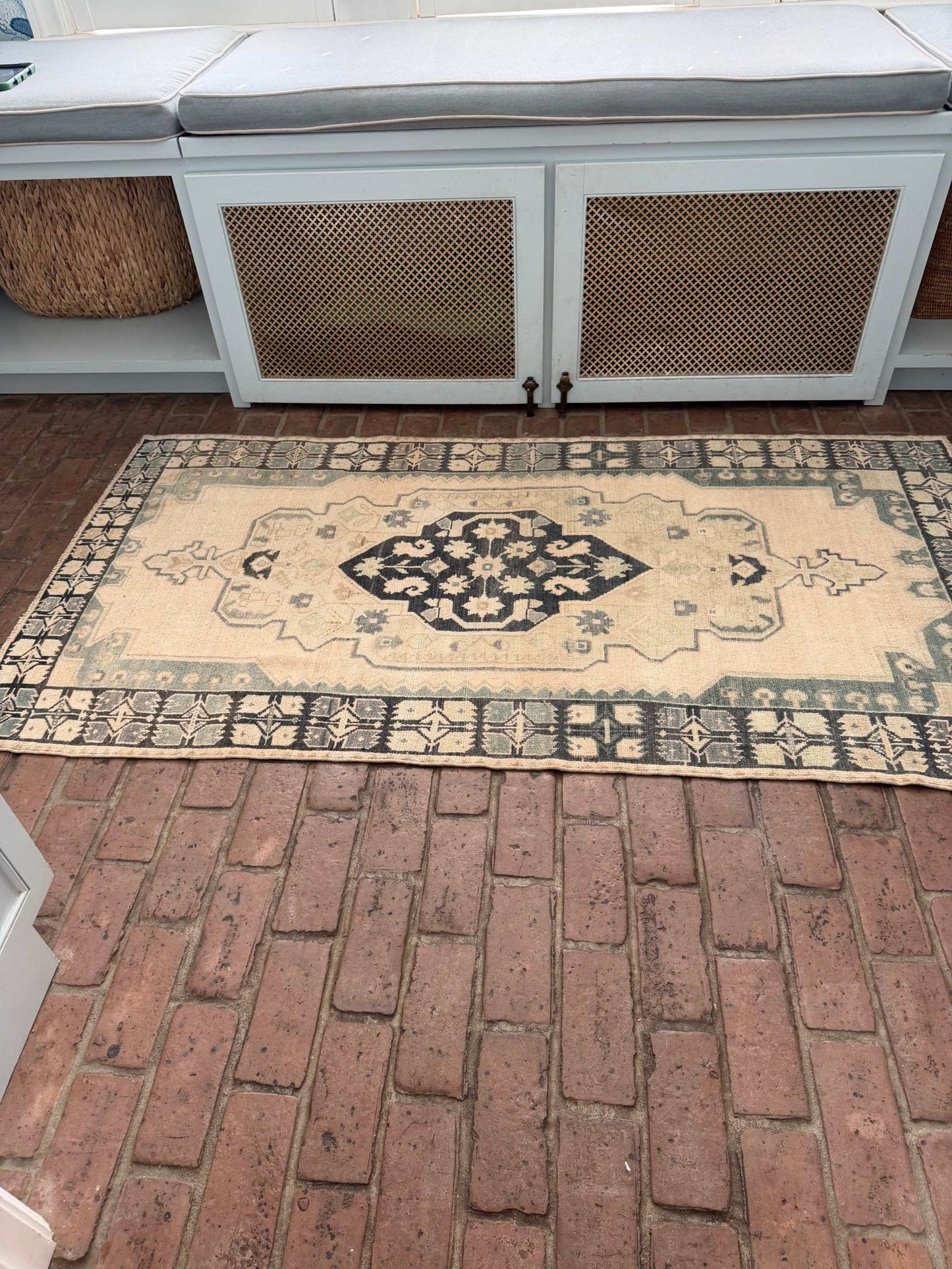 3'4" x 6'5" hand knotted area rug with blues, greens, taupe, and a hot pink accent spot
