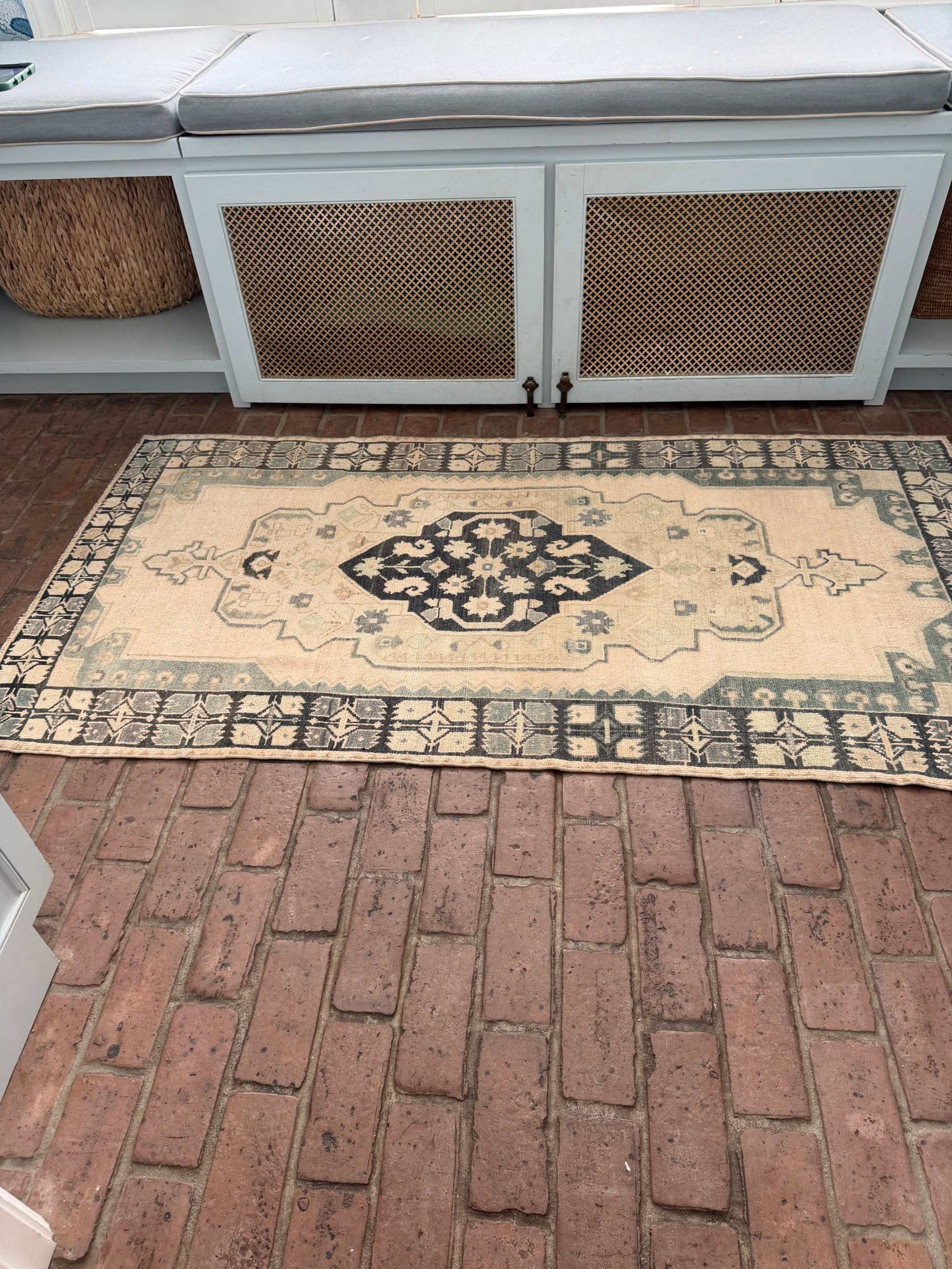 3'4" x 6'5" hand knotted area rug with blues, greens, taupe, and a hot pink accent spot