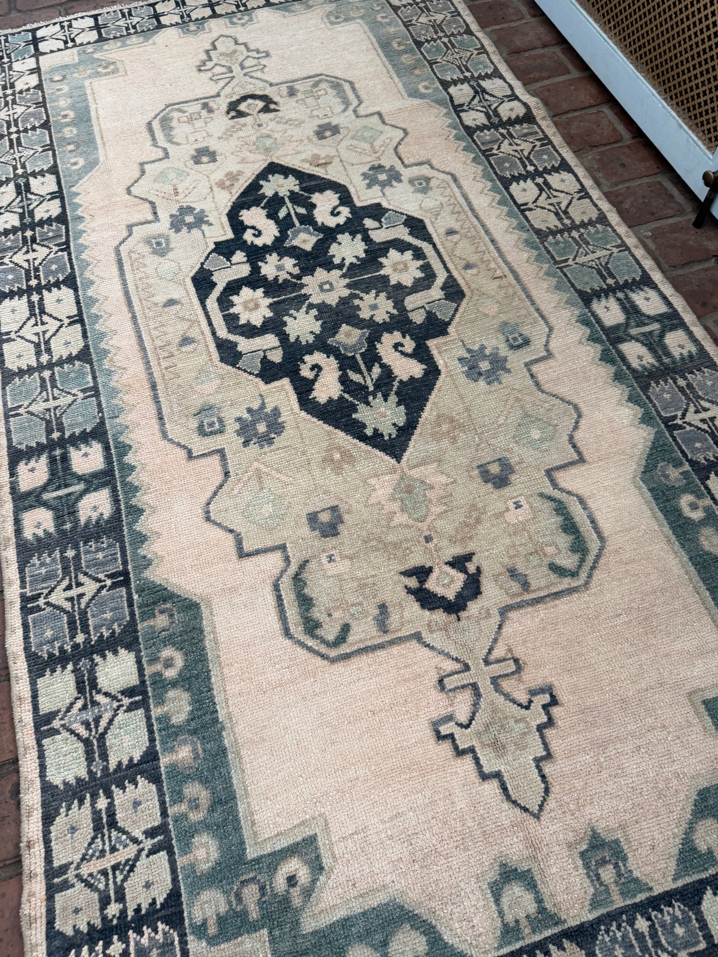 3'4" x 6'5" area rug with blues, greens, taupe, classic medallion, and unique hot pink spot