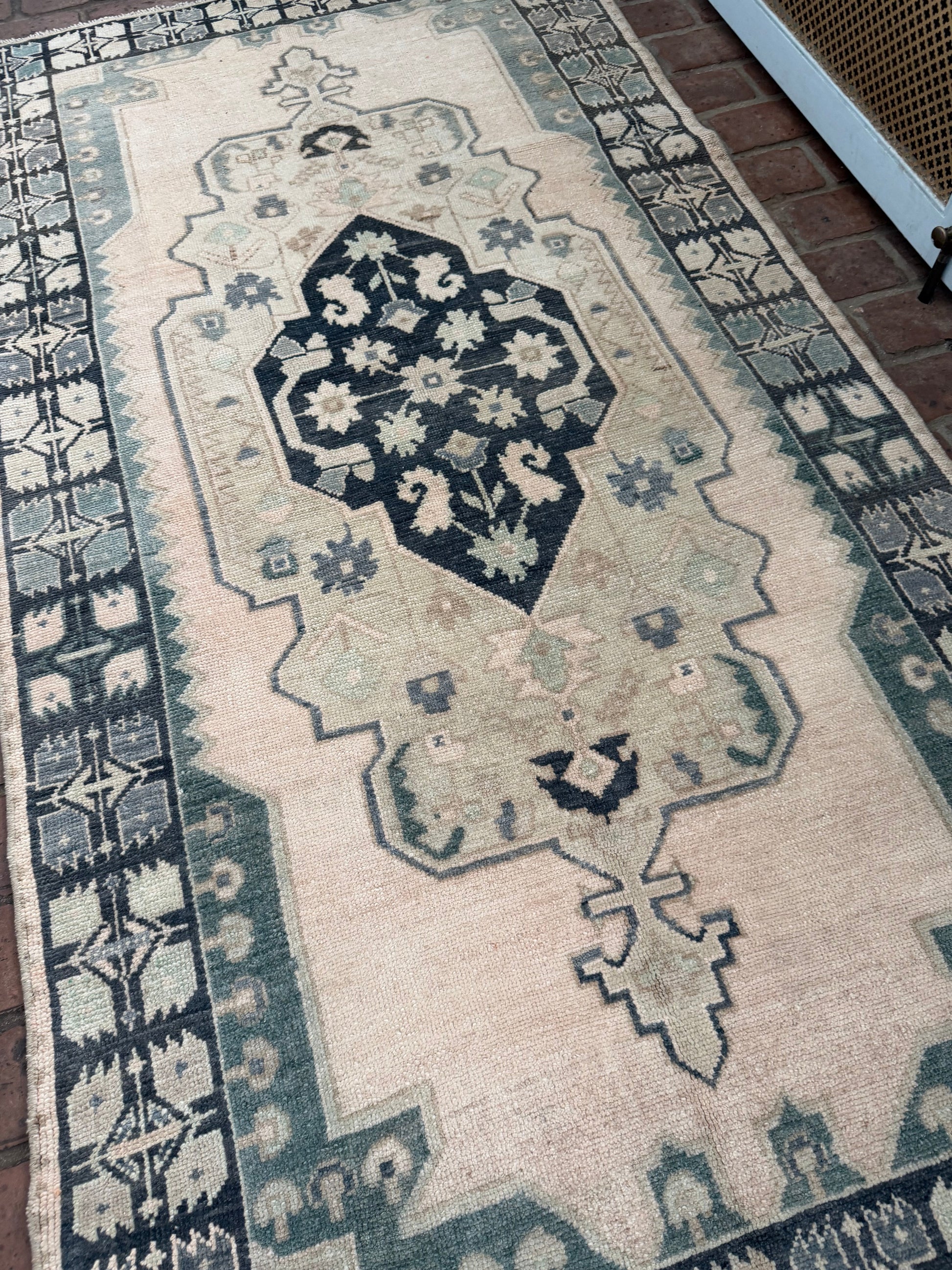 3'4" x 6'5" area rug with blues, greens, taupe, classic medallion, and unique hot pink spot